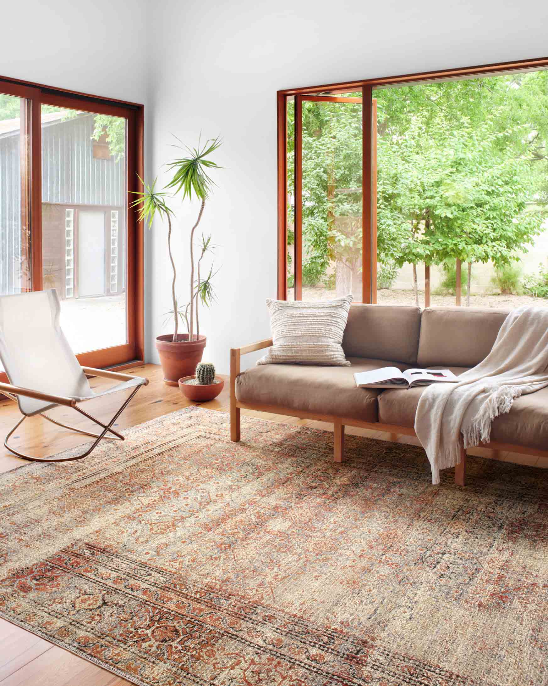 Area rug with distressed medallion pattern and red-brick accents on natural base