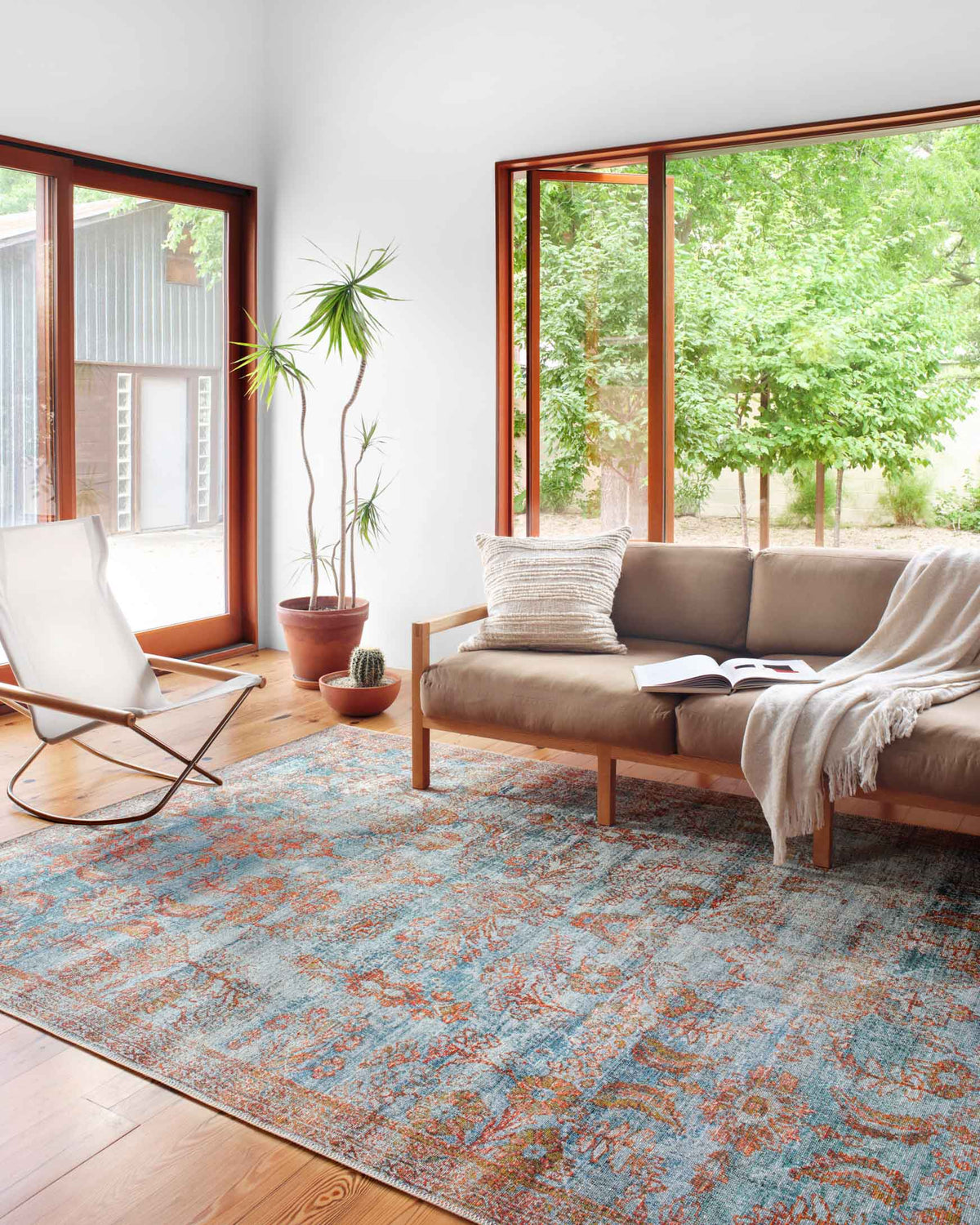 Traditional power-loomed area rug in ocean blue with rust-orange and medallion-style motifs.