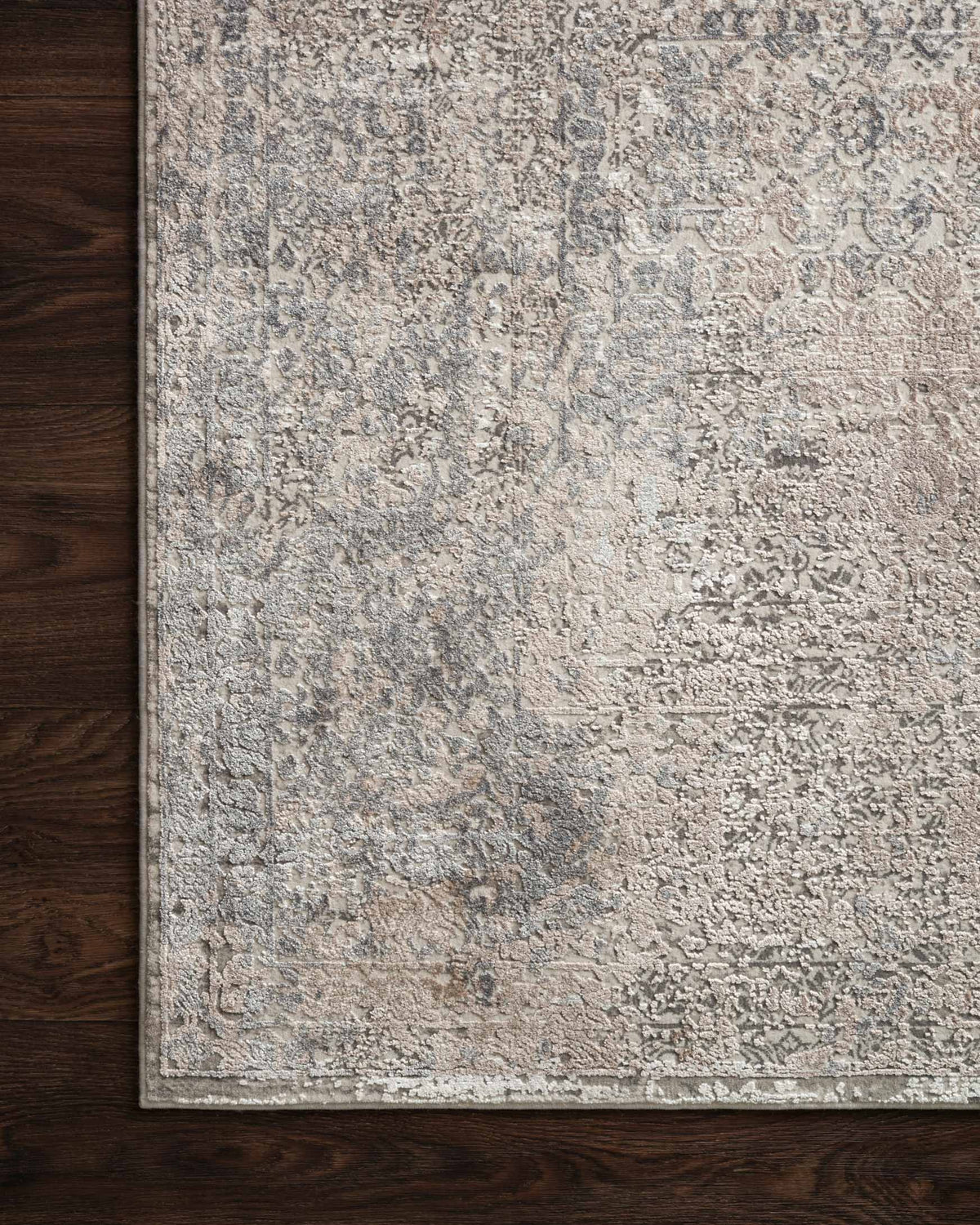 Ivory and pebble power-loomed rug edge with detailed distressed pattern texture