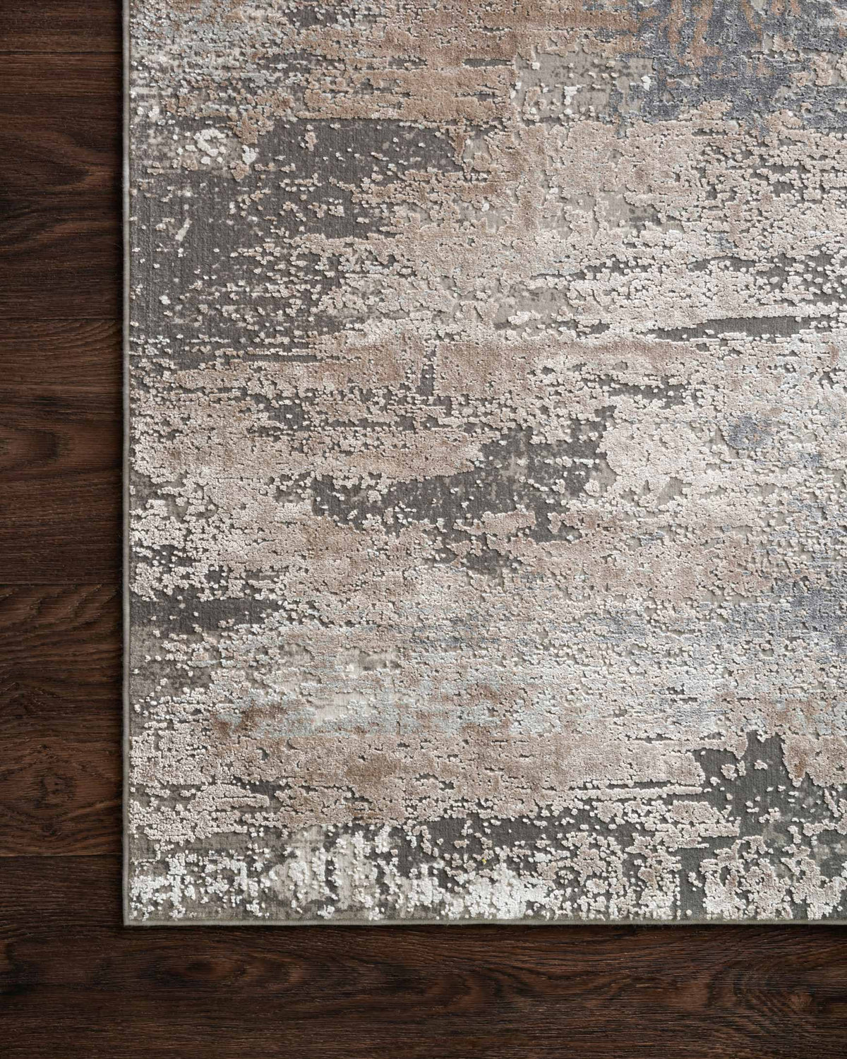 Ivory and sand abstract distressed area rug with mottled pattern and clean edge