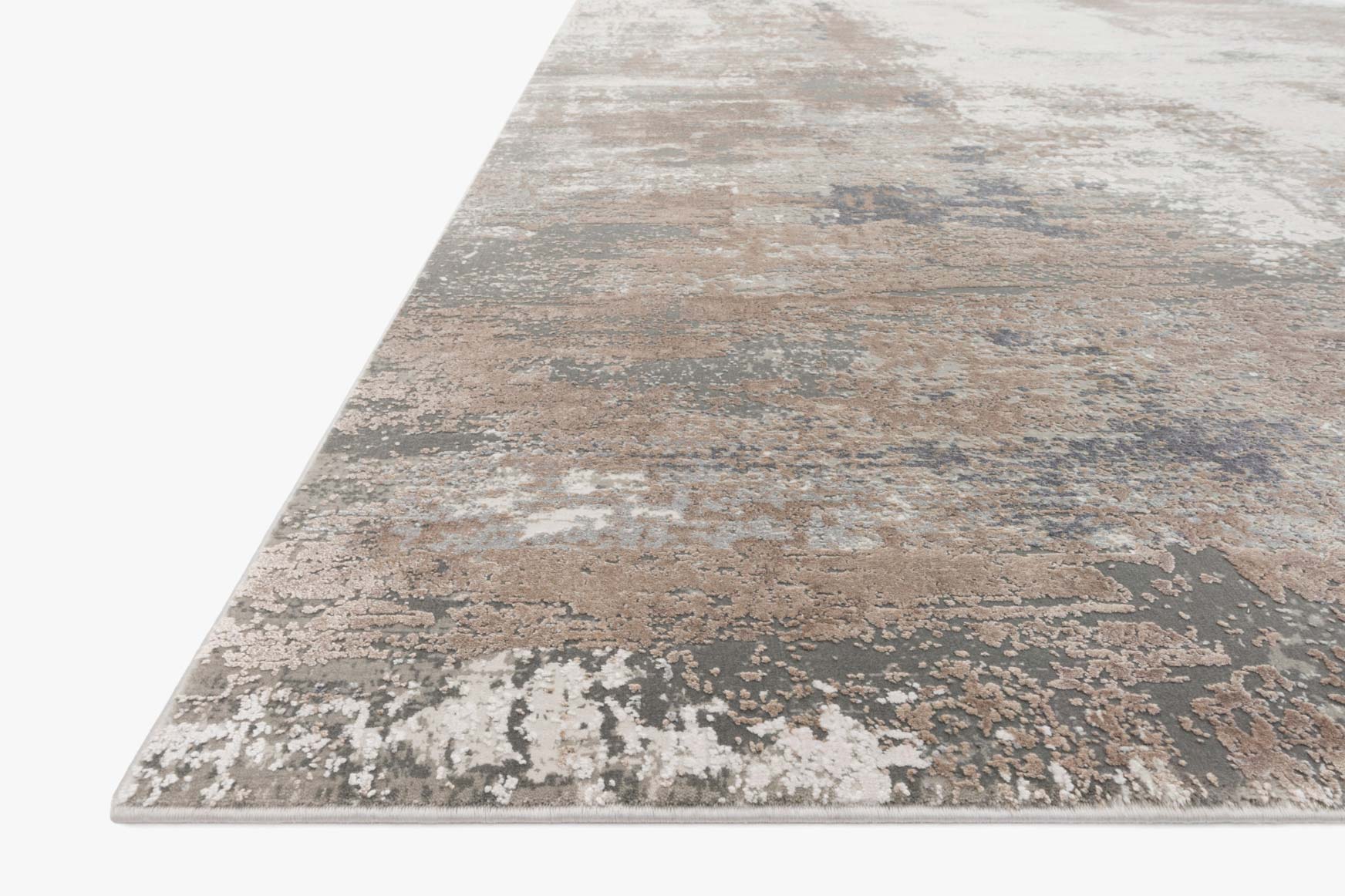 Ivory and sand abstract distressed area rug with visible corner and textured pile