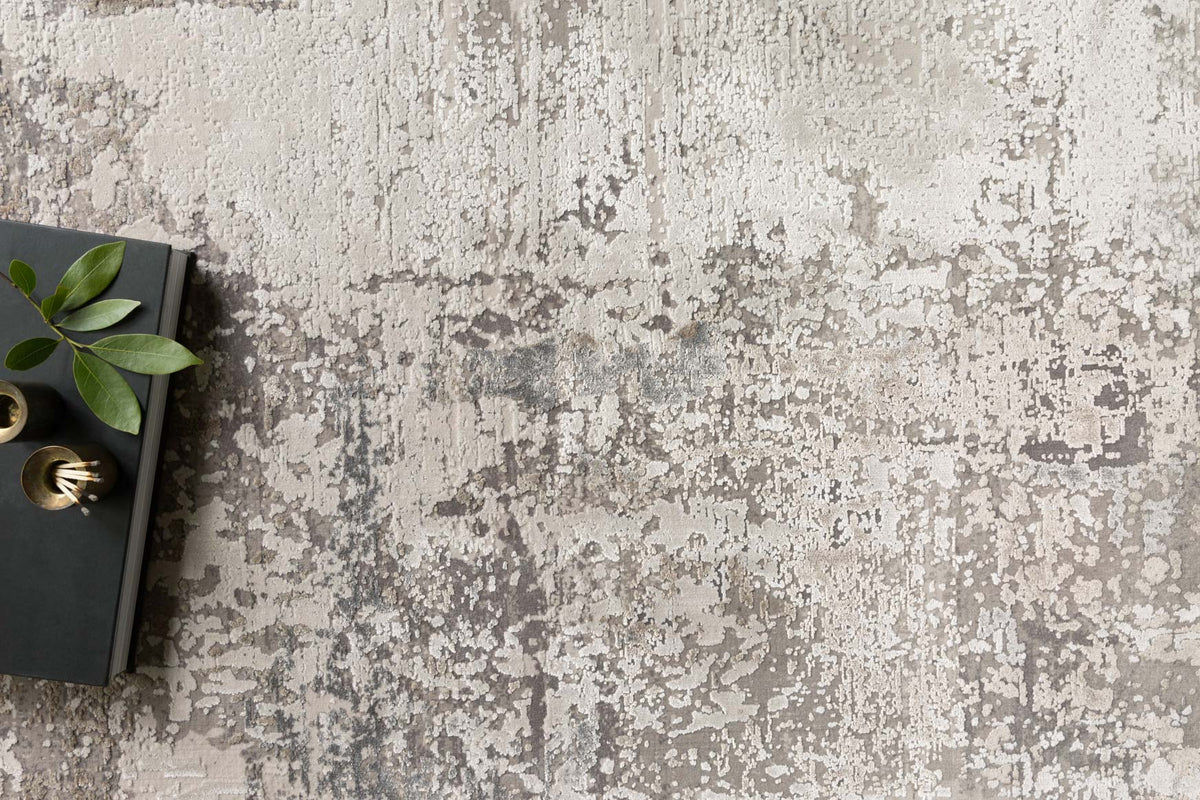 Ivory and sand abstract textured area rug with mottled speckled finish