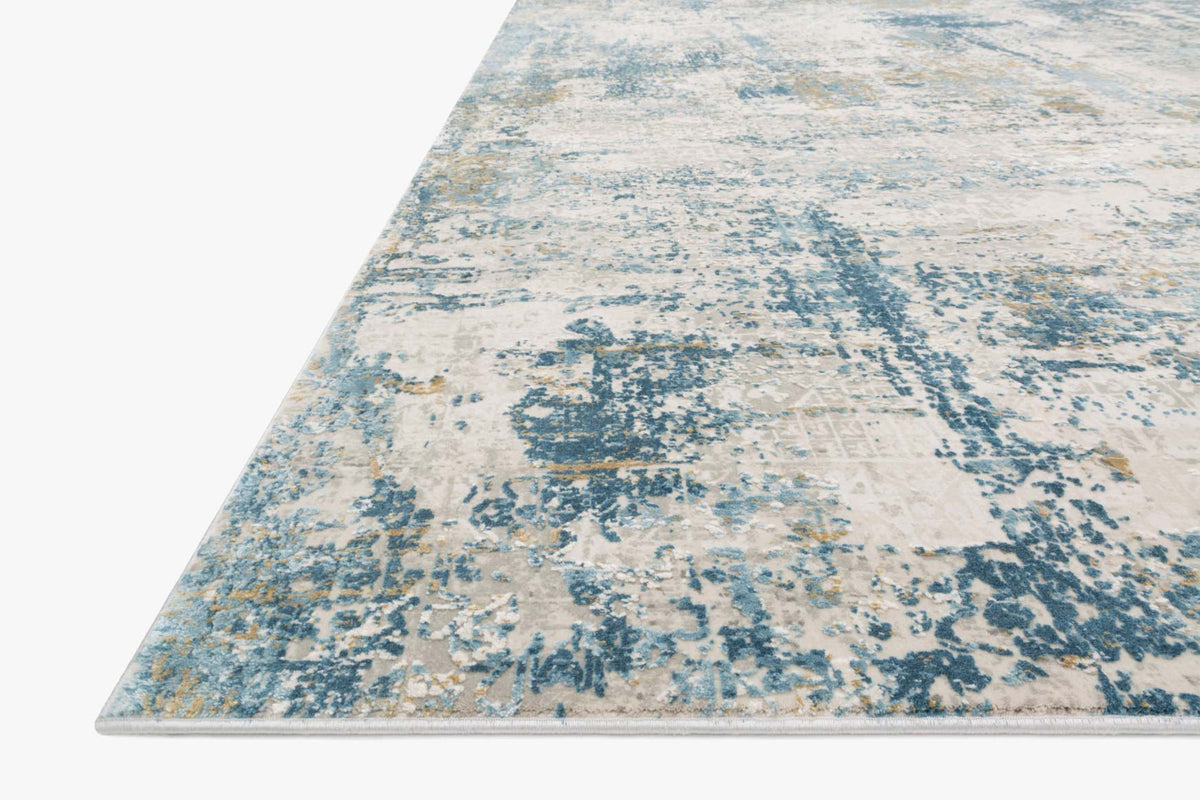 Abstract rectangular rug in grey and blue with distressed blocklike motifs.