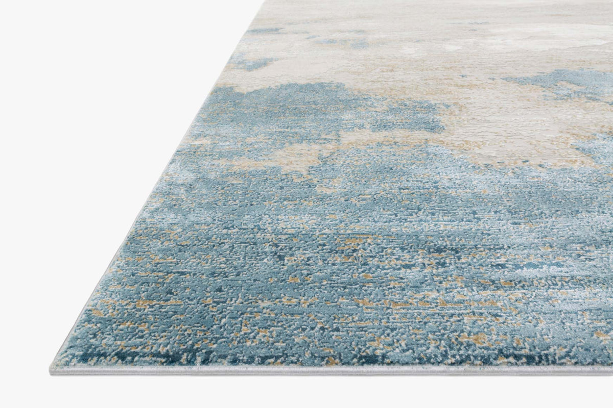 Sand-and-ocean power-loomed rug showing corner edge and textured low-pile surface