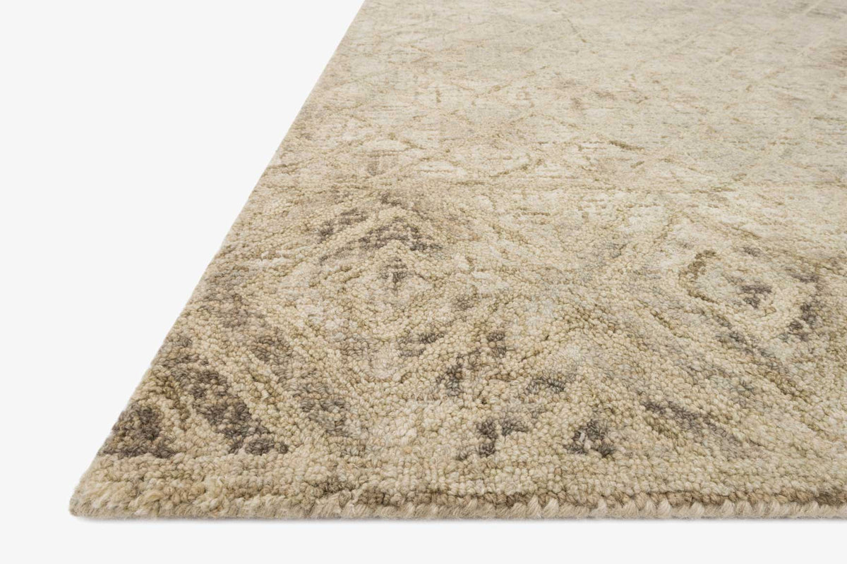 Sand hooked rug corner with close-up looped texture and faded geometric motifs