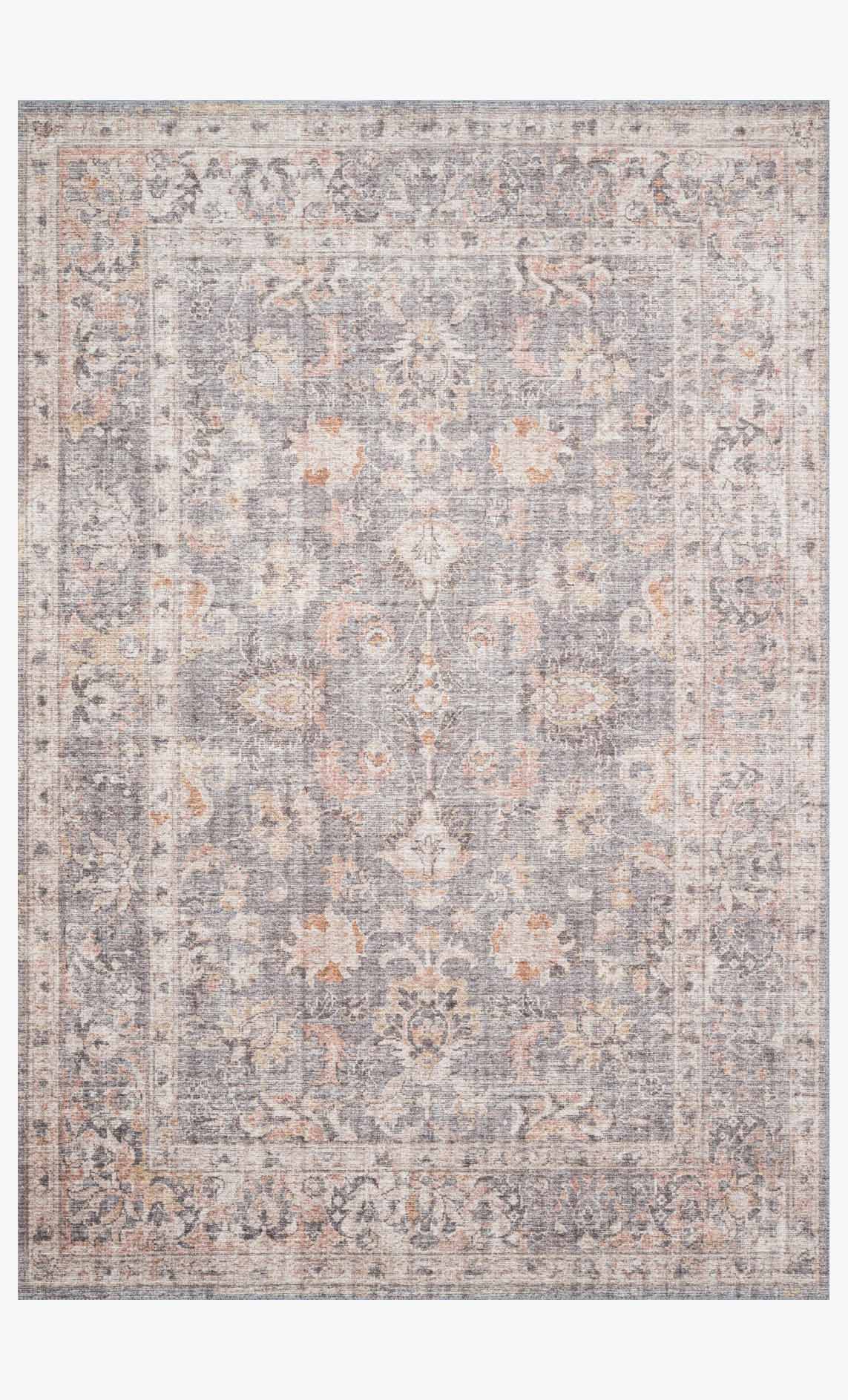 Grey and apricot traditional area rug with ornate distressed pattern and bordered edges.