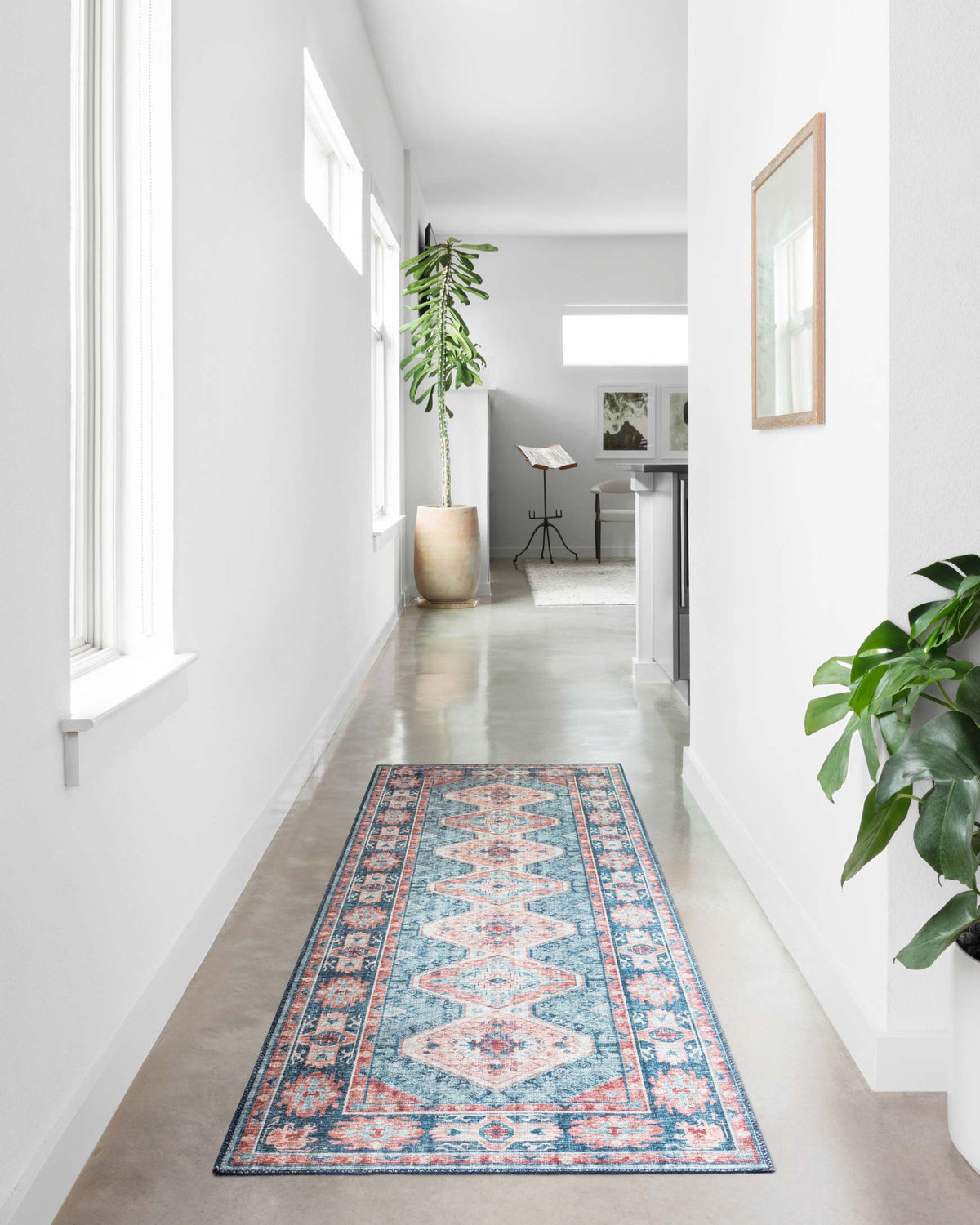 Turquoise traditional rug runner with terracotta and cream medallion designs in hallway