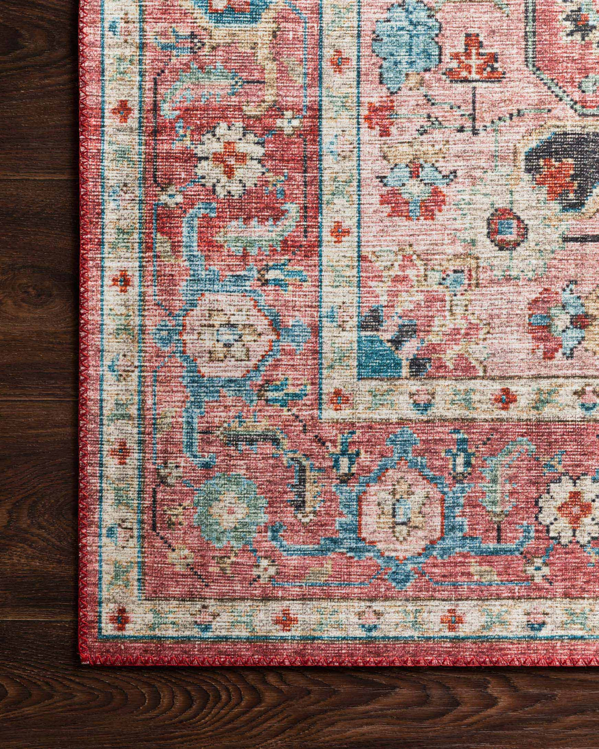 Upright rug edge on dark wood floor with brick and ocean ornate pattern and distressed texture