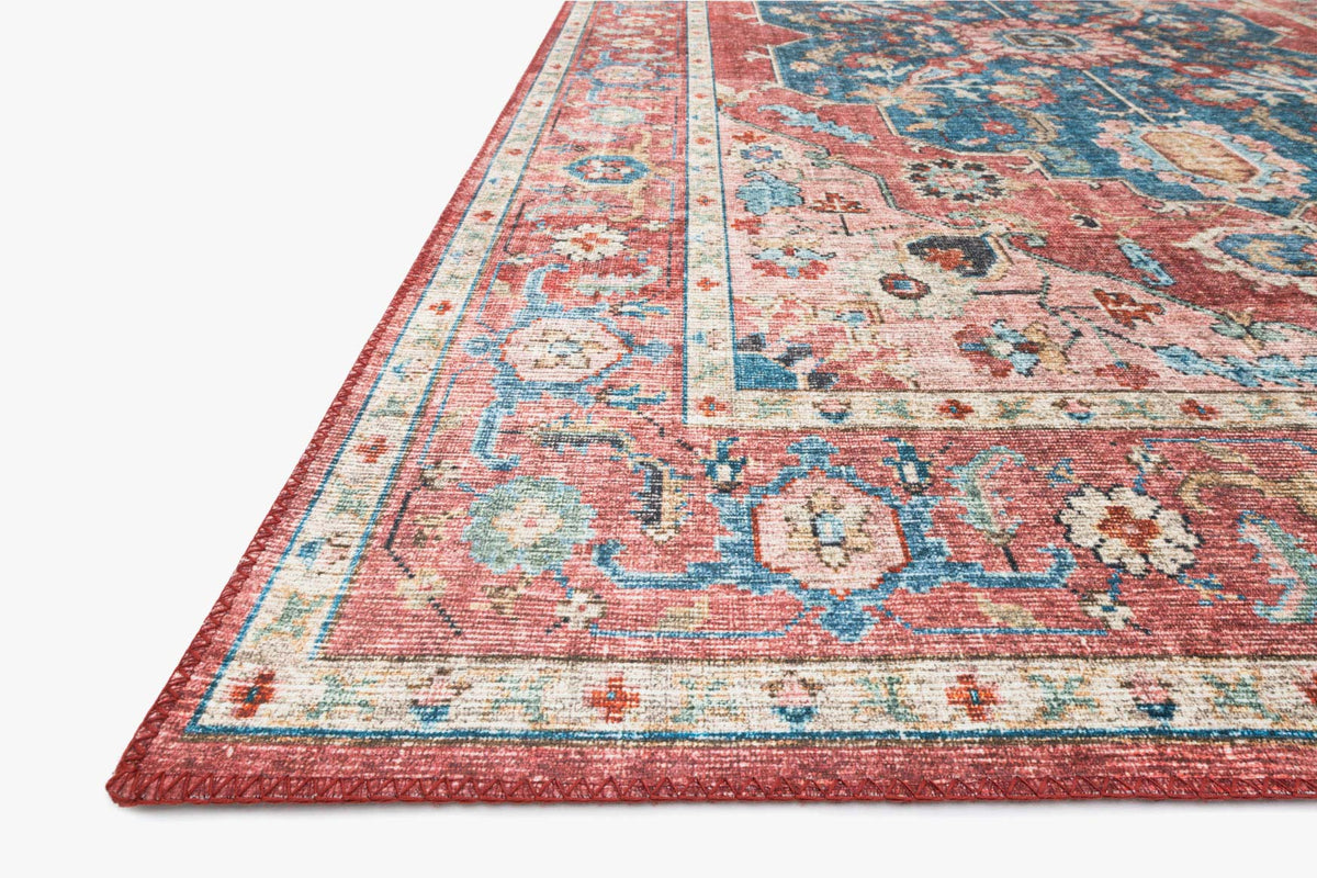Traditional rug with bordered striping and distressed motifs in brick red, teal, and cream