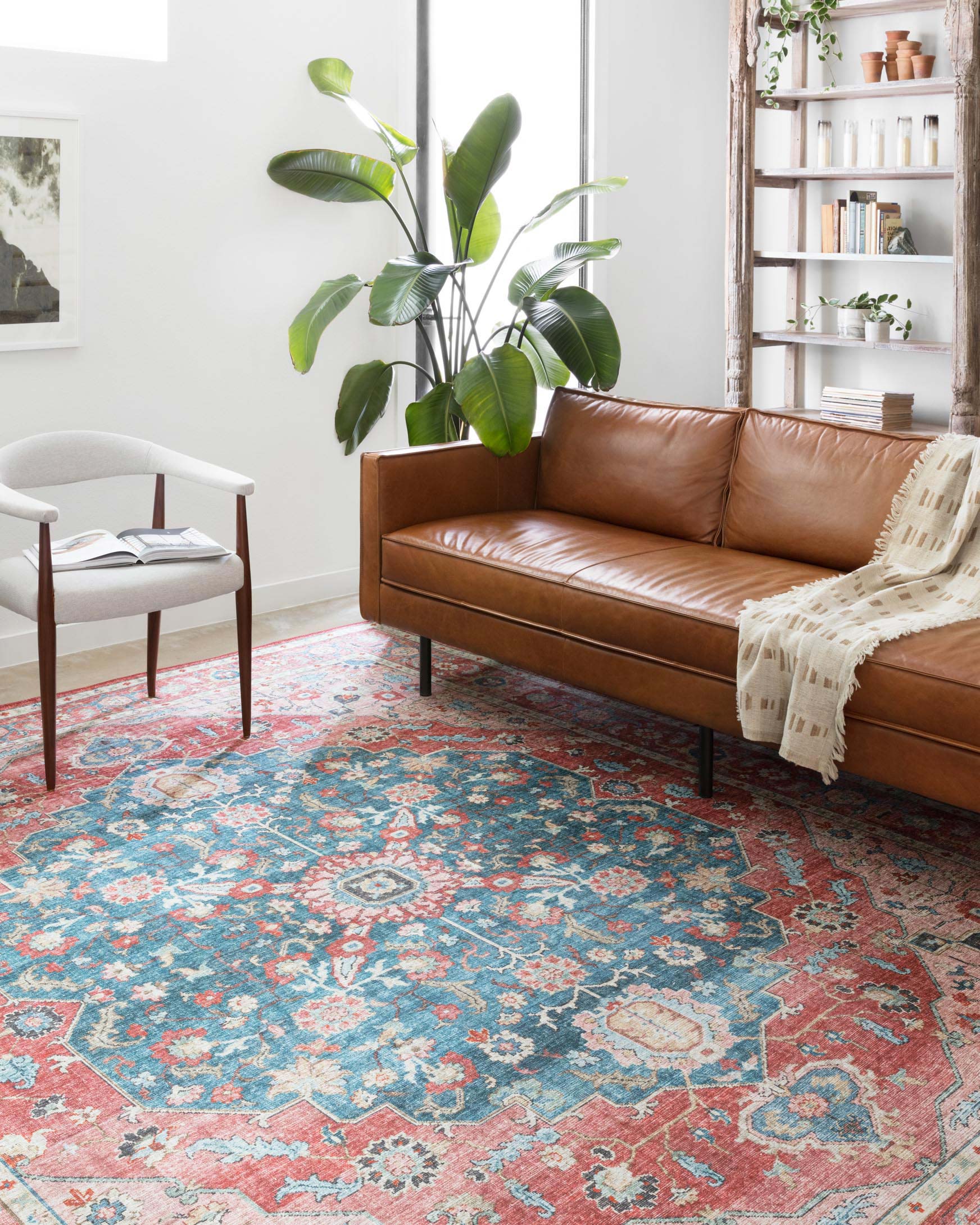Traditional power-loomed rug with distressed floral motifs in ocean blue and brick red