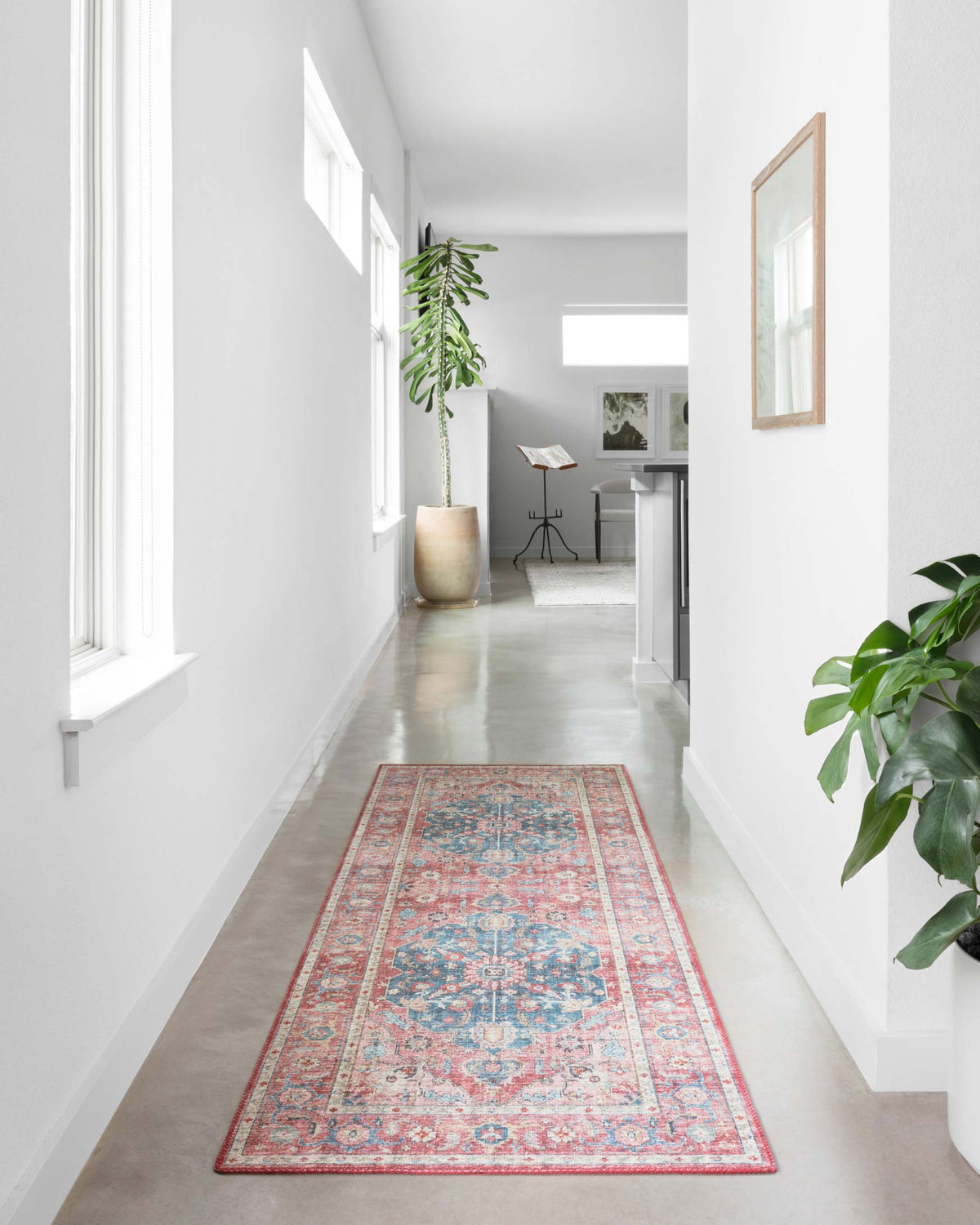 Rectangular brick and ocean patterned rug runner with ornate motif in a hallway