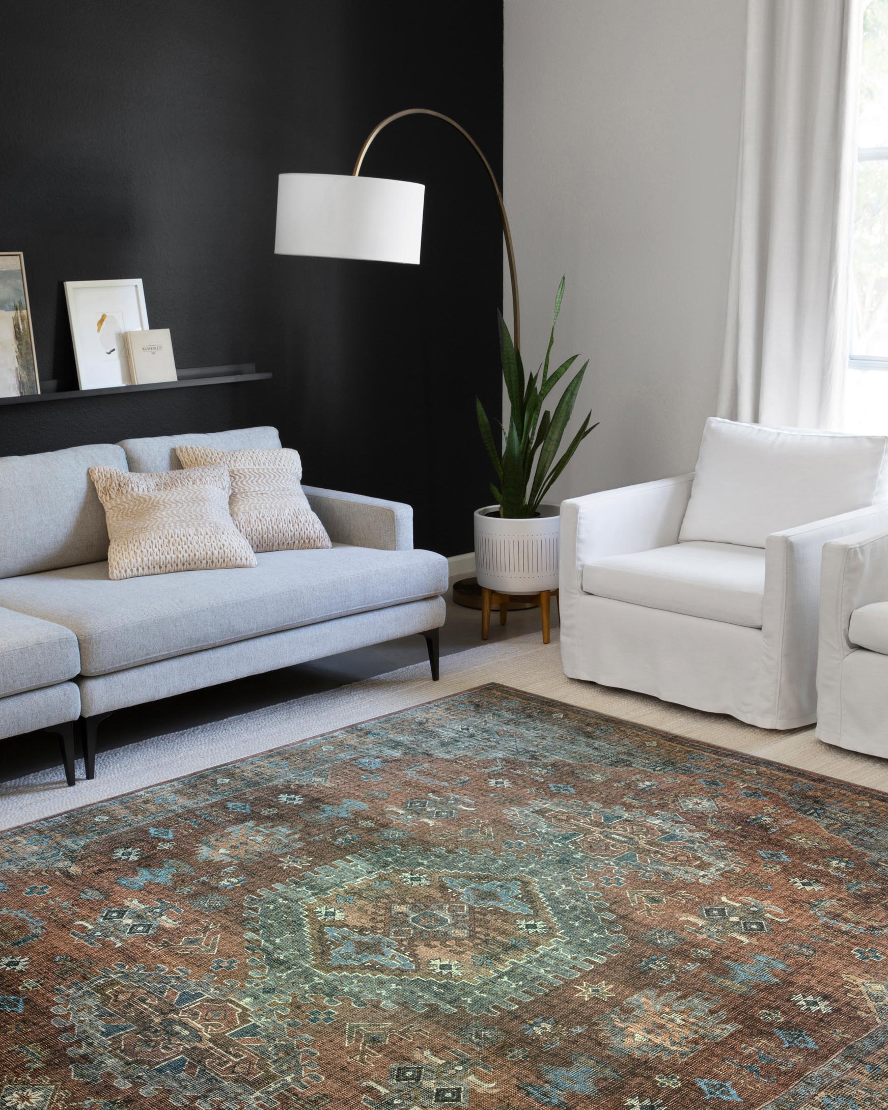 Traditional power-loomed rug in terracotta and sky with ornate geometric center medallions.