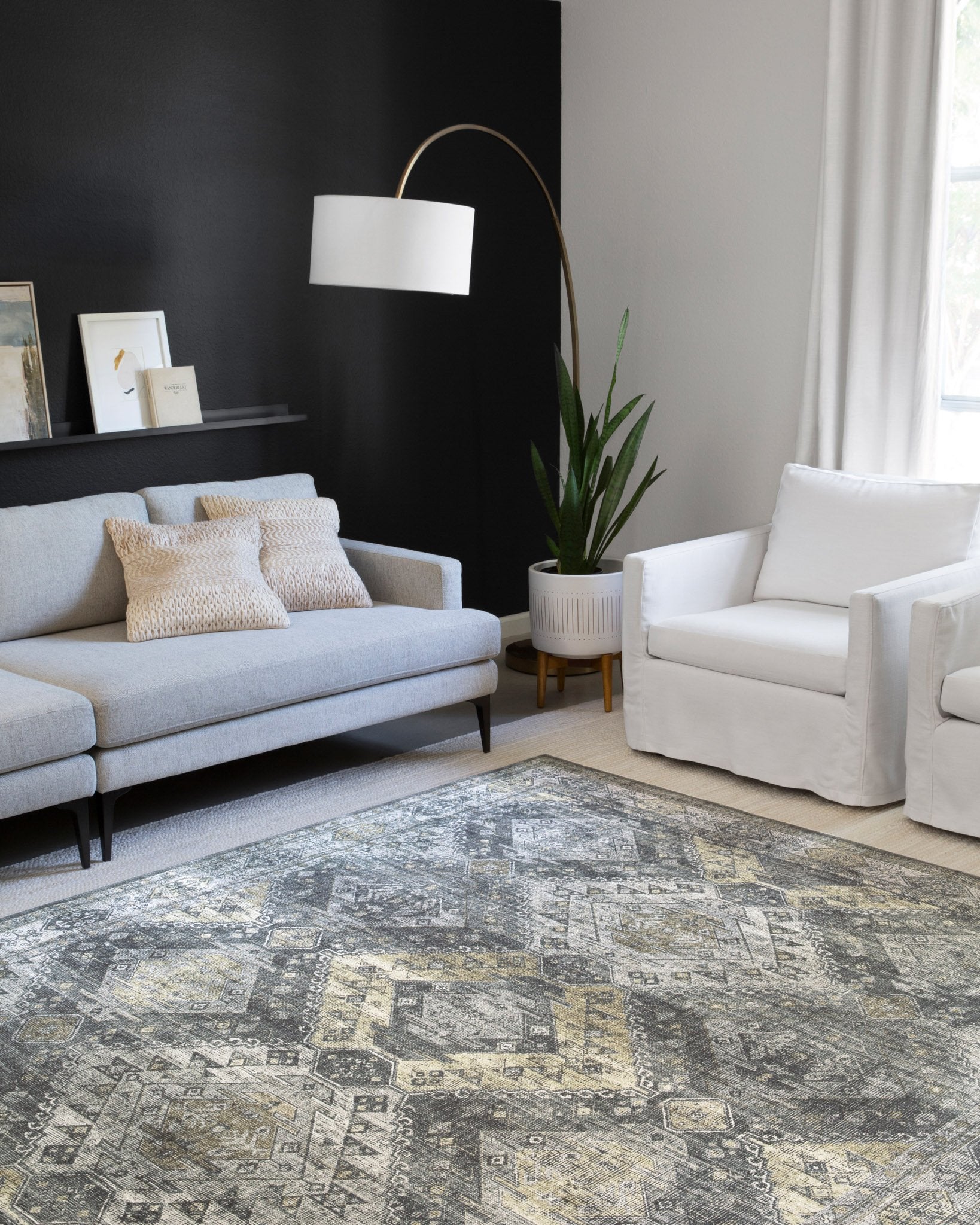 Geometric graphite and silver rug with gold-toned highlights on display in a living room