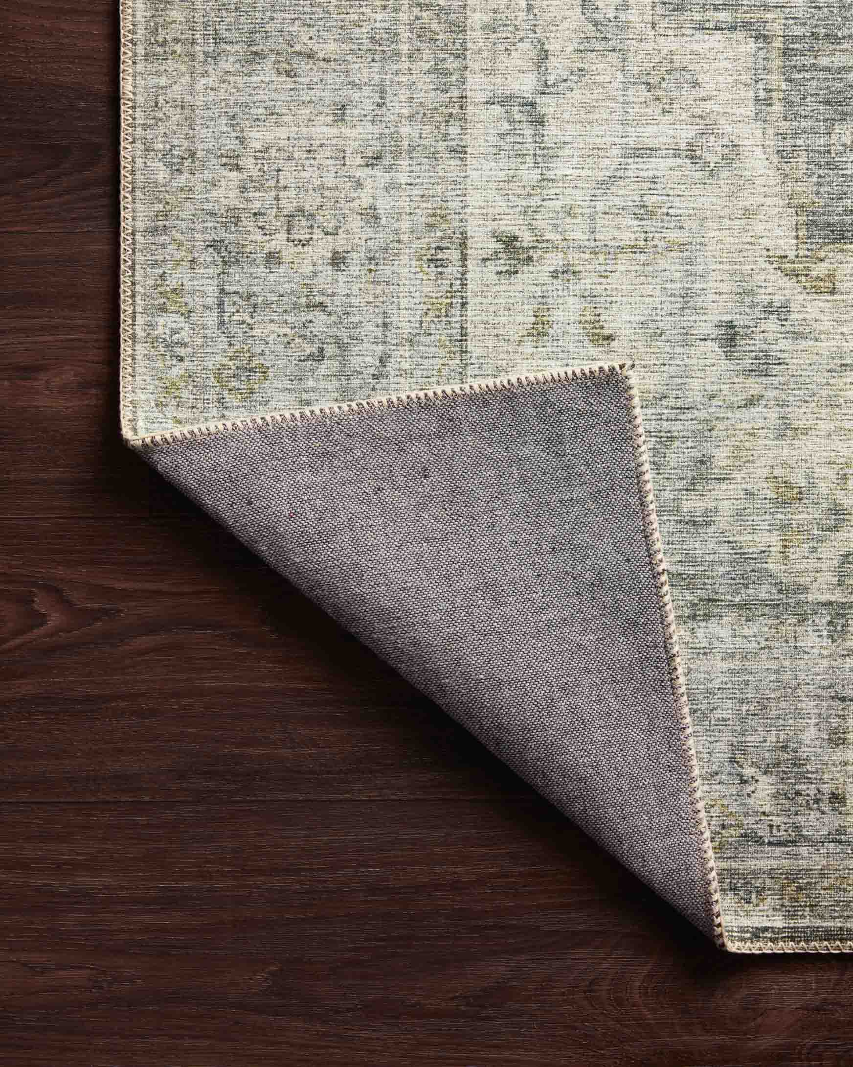 Traditional power-loomed rug corner with charcoal-and-dove top and gray underside