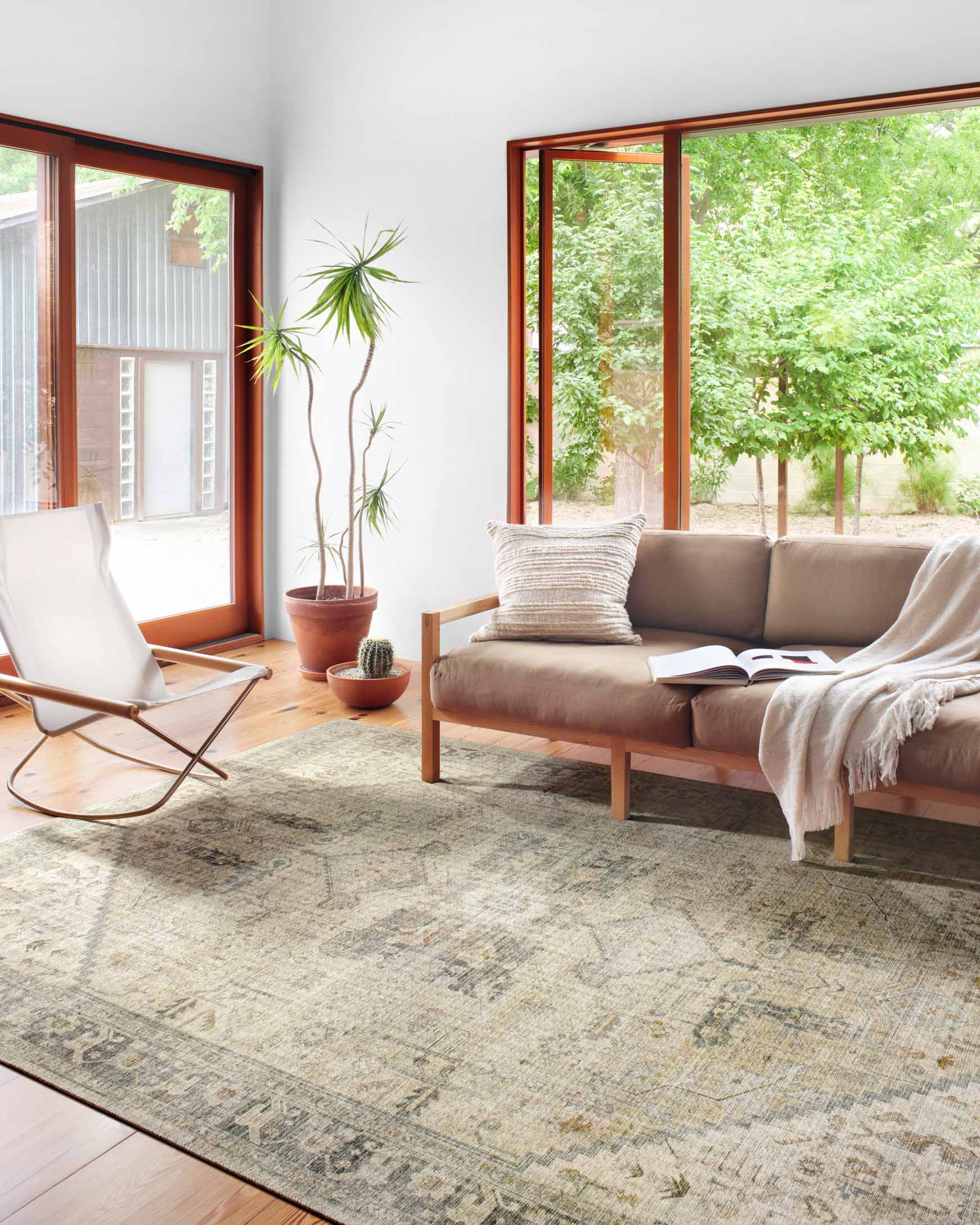 Rectangular natural sand rug with distressed traditional pattern on a hardwood floor