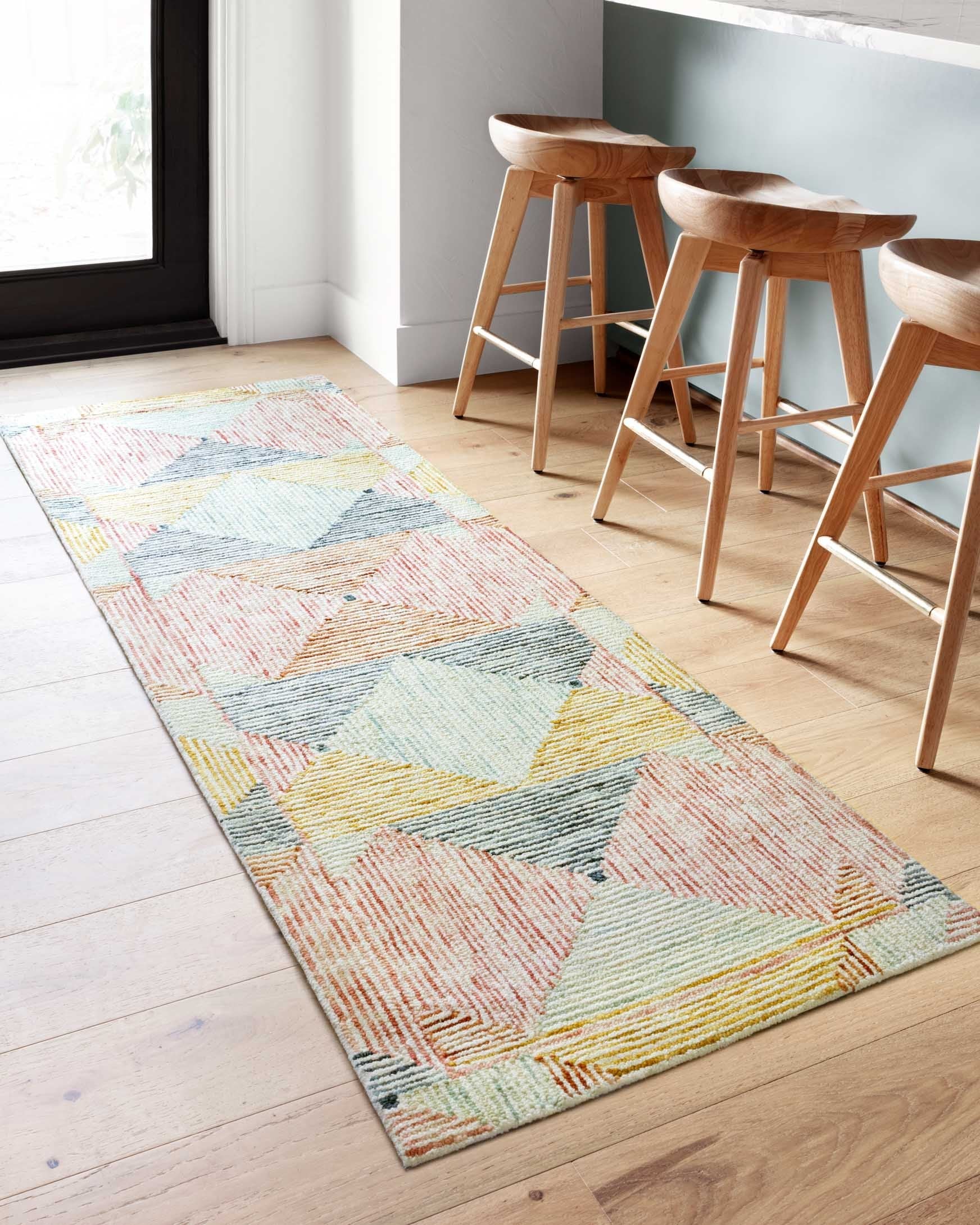 Contemporary hooked rug with repeating diamond pattern in ivory, blue, coral, and yellow