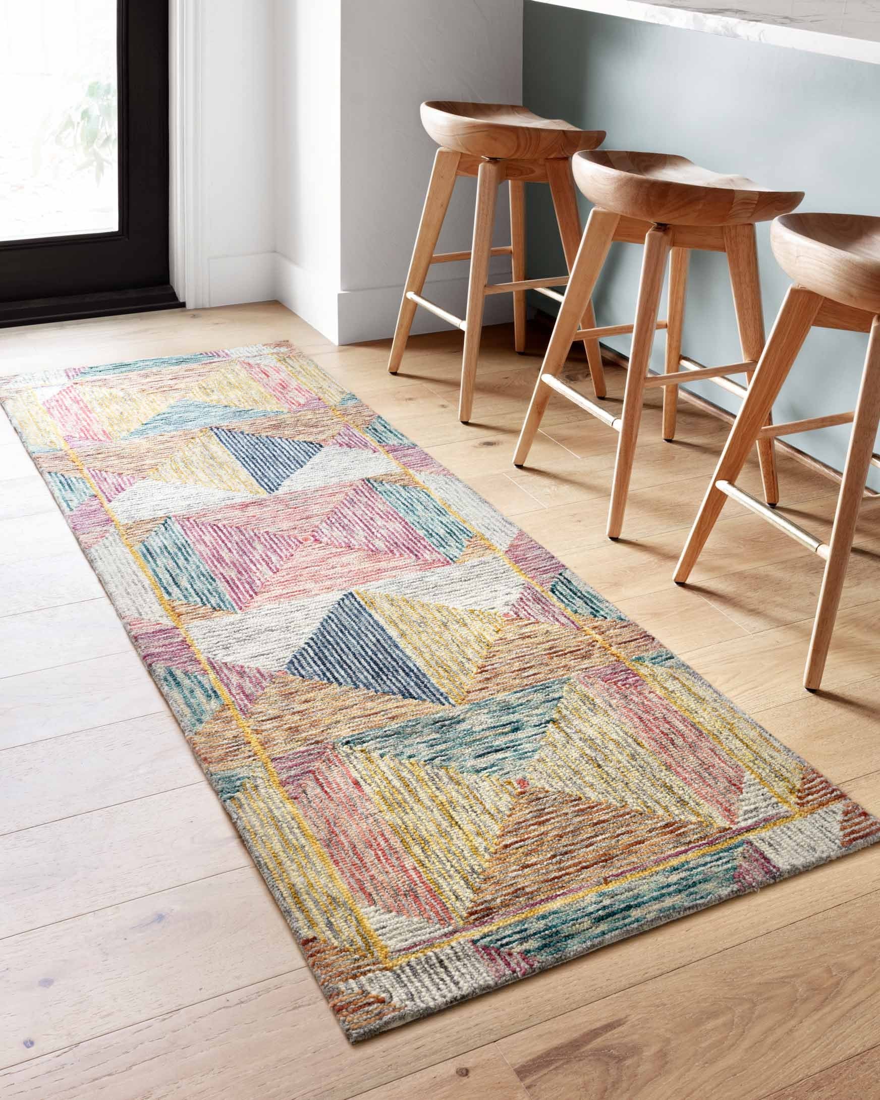 Long rectangular geometric hooked rug with multicolor zigzag and diamond pattern