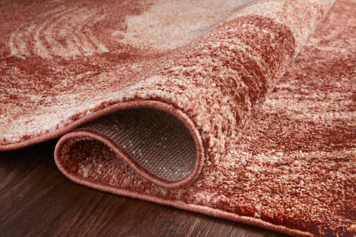 Rose and spice abstract area rug detail with bound edge and low pile