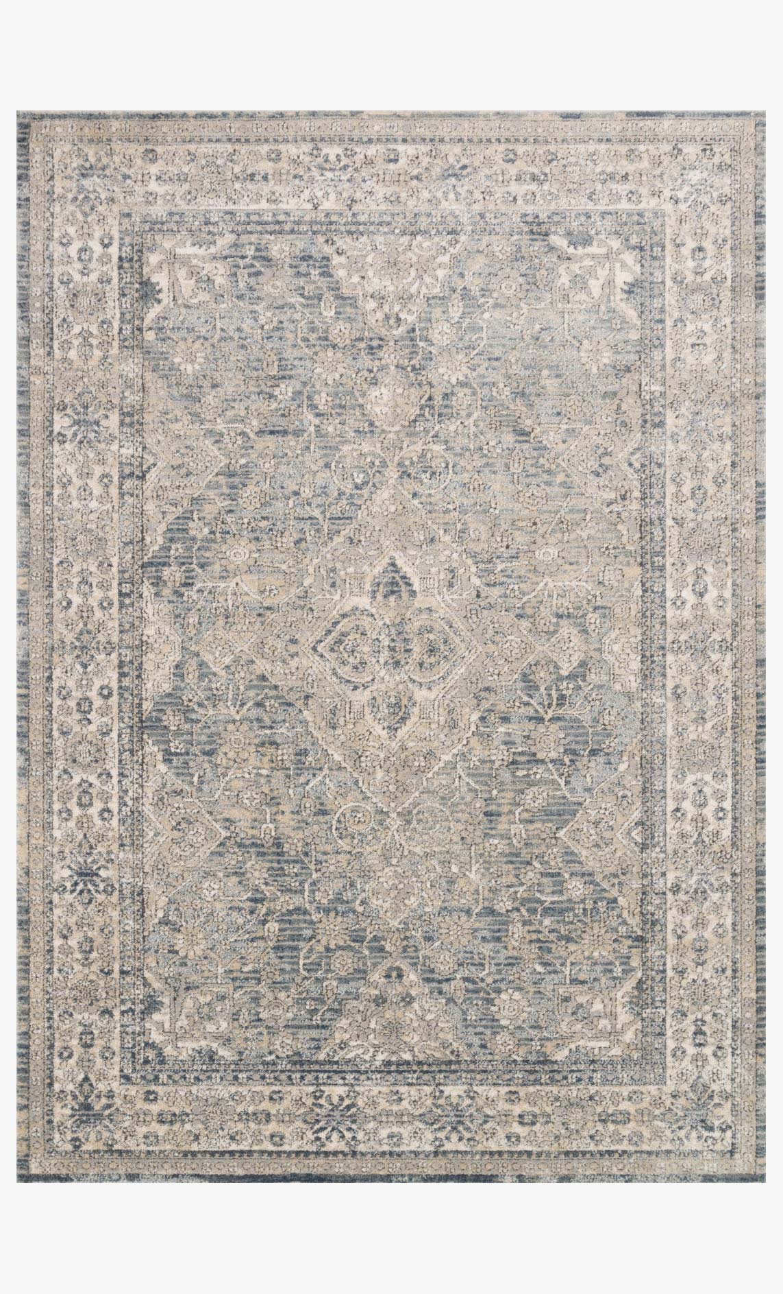 Power-loomed area rug in sky and natural with ornate medallion pattern and border
