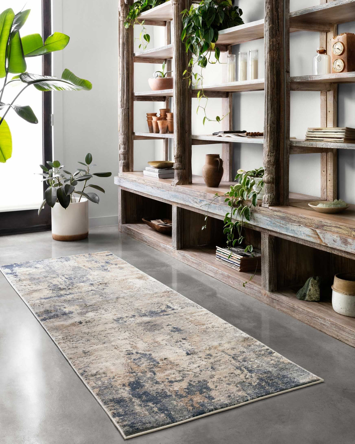 Rectangular power-loomed rug with distressed blue-gray and beige look and border.