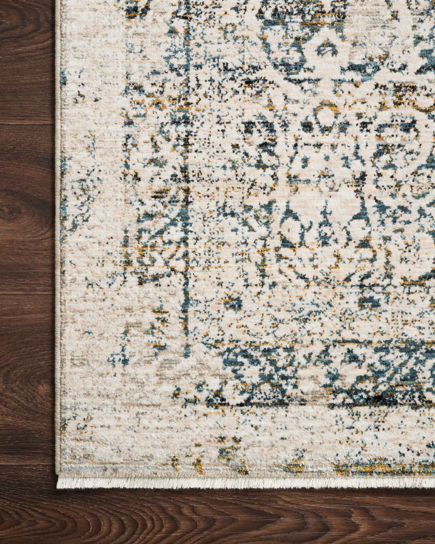 Close-up of traditional rug in beige with blue distressed motifs and low pile texture