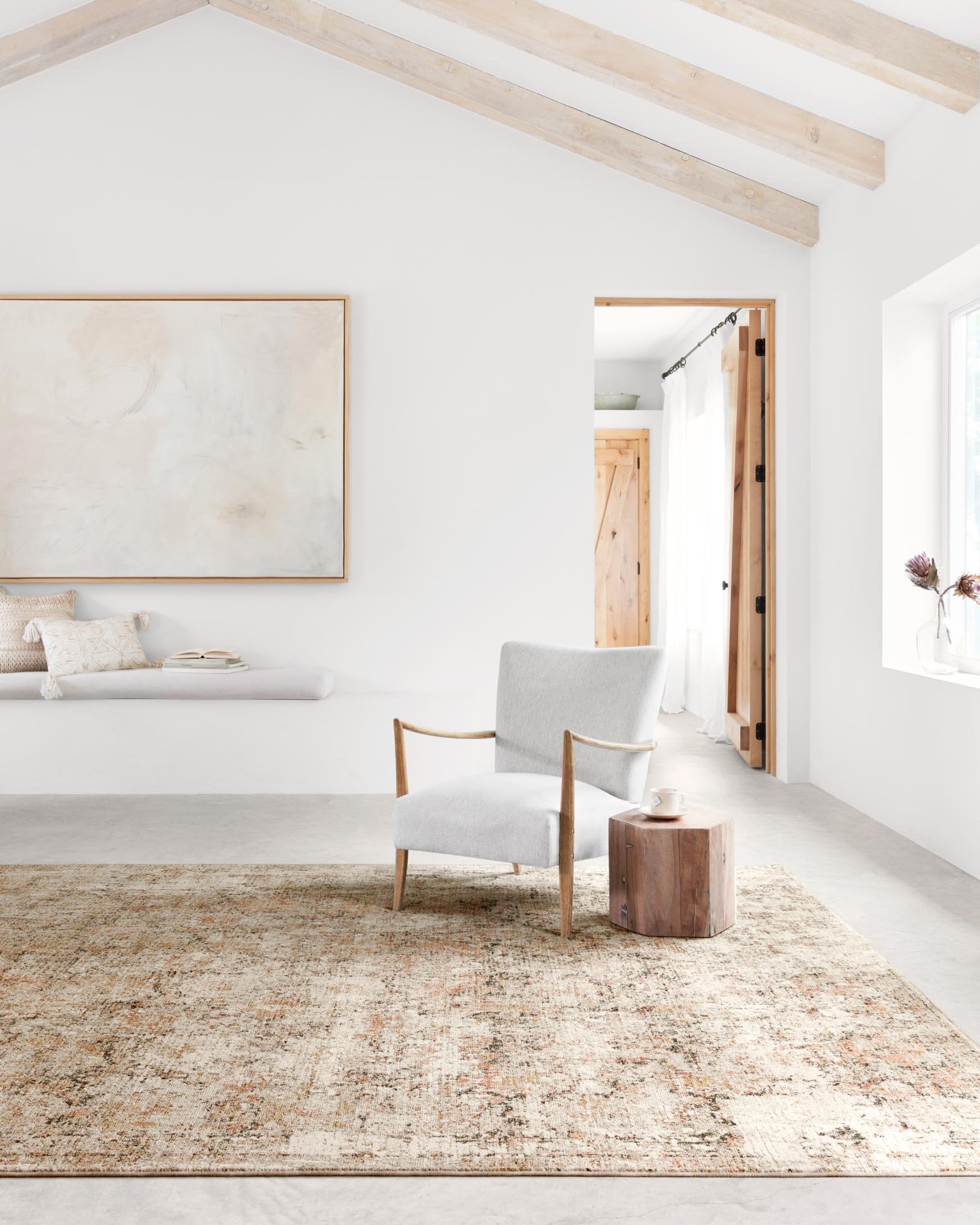 Area rug in taupe and gold with abstract distressed pattern and textured flat weave