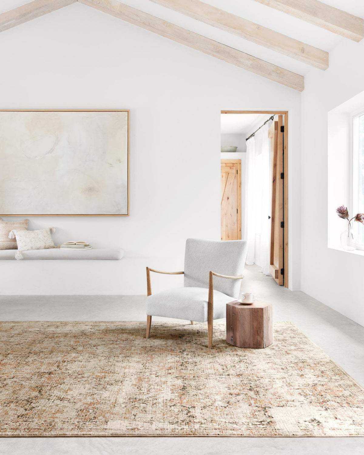 Taupe and gold speckled area rug laid out on the floor in a living room