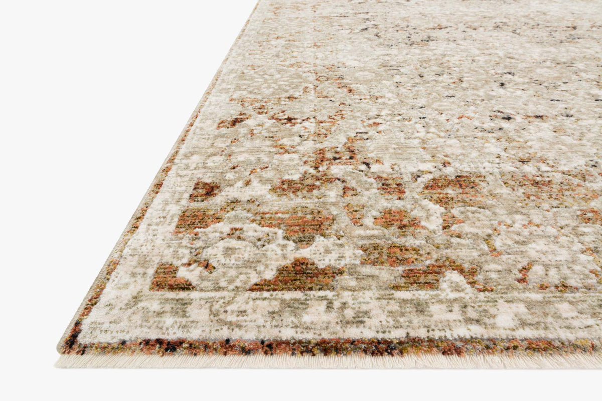 Corner close-up of natural-and-rust distressed power-loomed rug with multicolor motifs