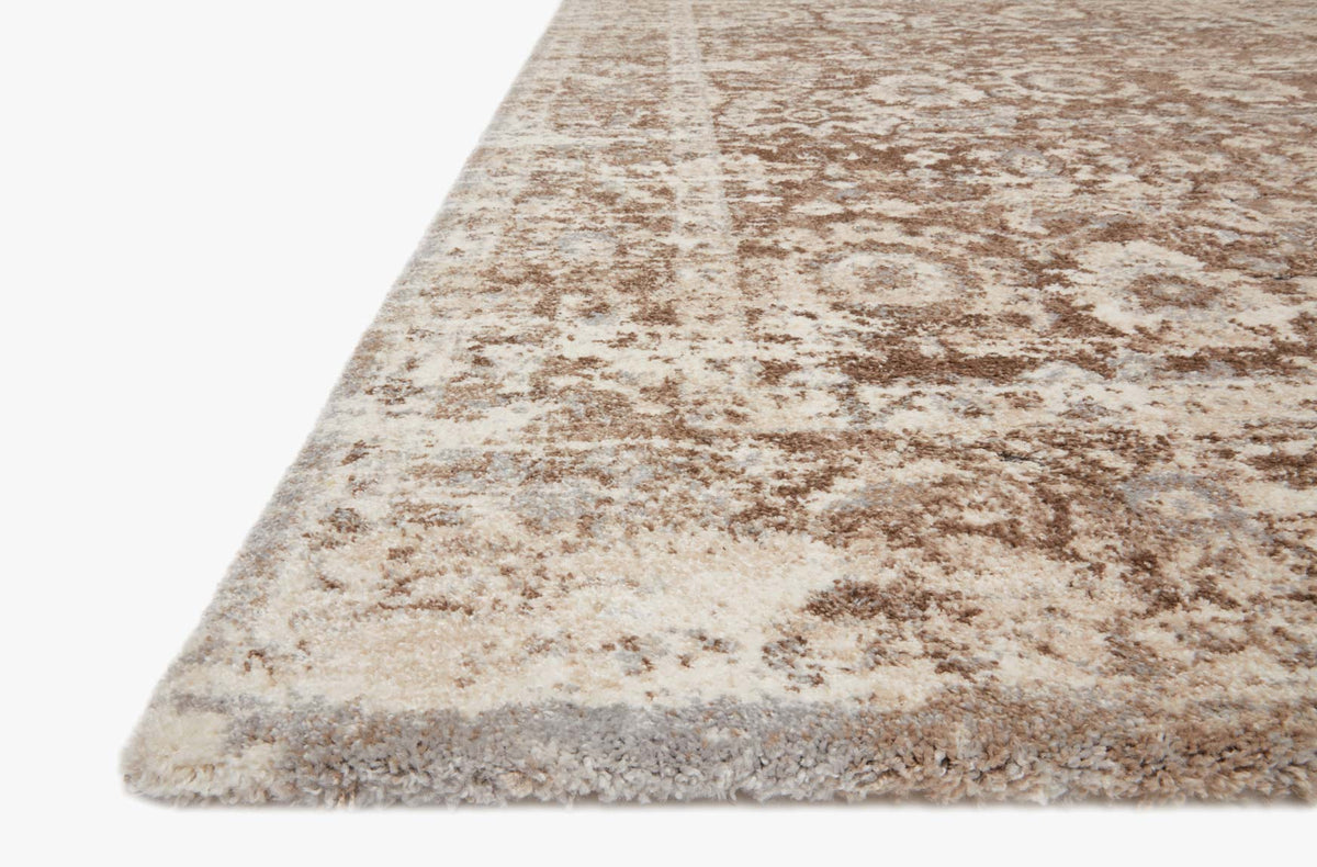Power-loomed rug corner detail, natural base with mocha distressed motif pattern