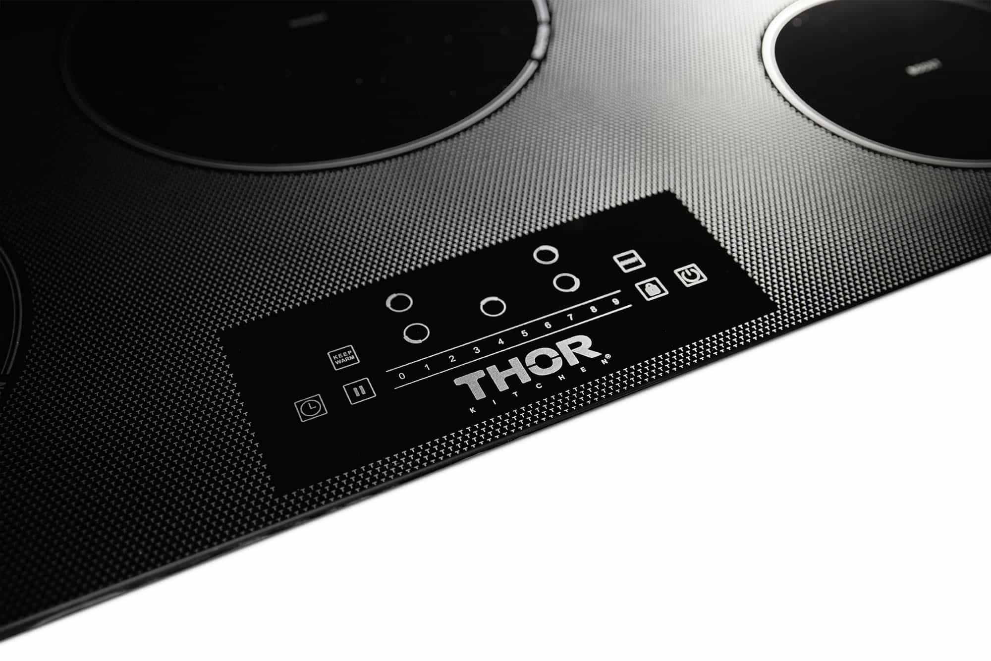 Black induction cooktop front control panel with five burner zones and touch buttons