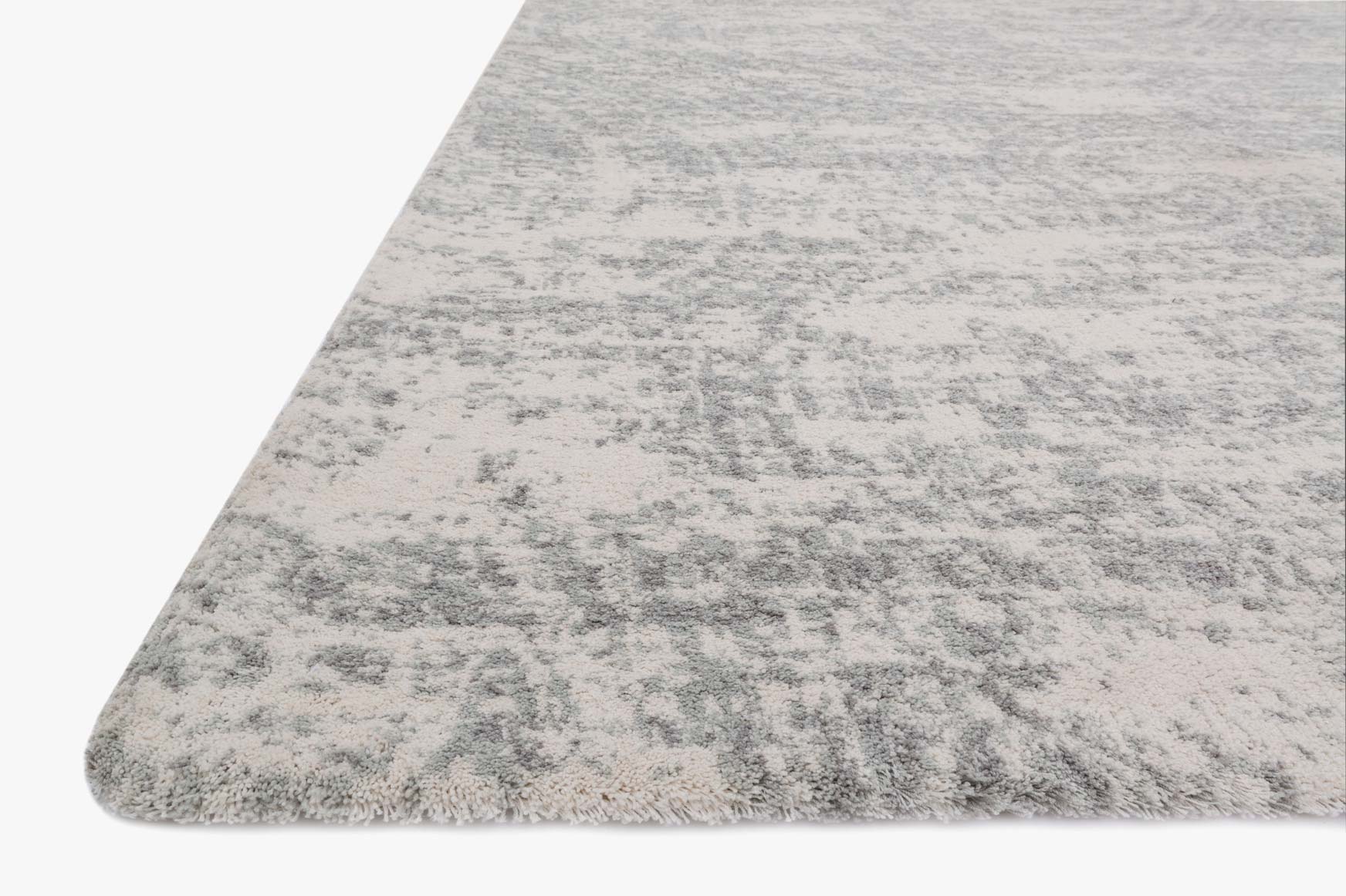 Loloi Torrance rug close-up corner, light grey abstract distressed pattern with plush pile