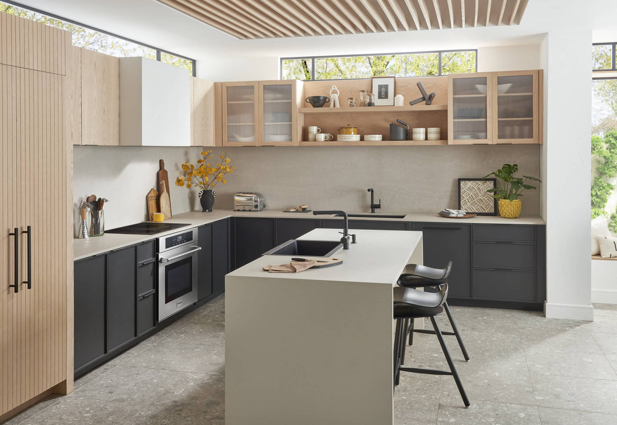 Black electric cooktop with round burner zones on a kitchen island countertop