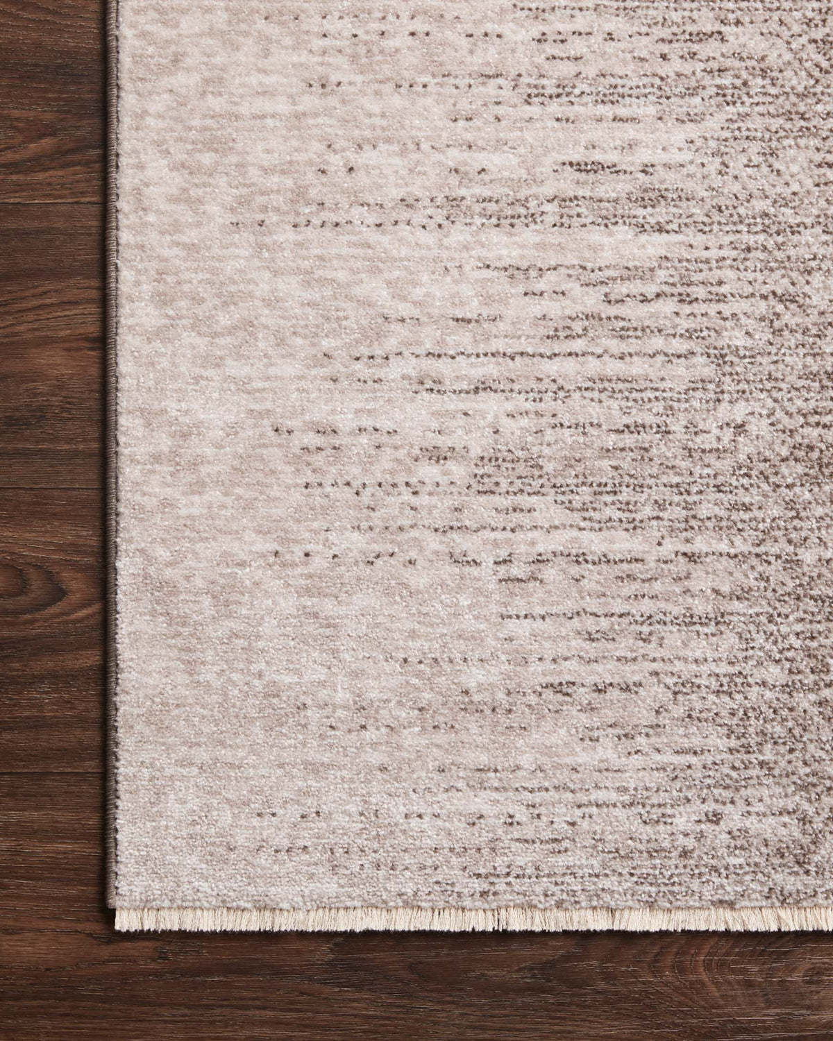 Taupe and dove traditional rug corner with short fringes and mottled surface