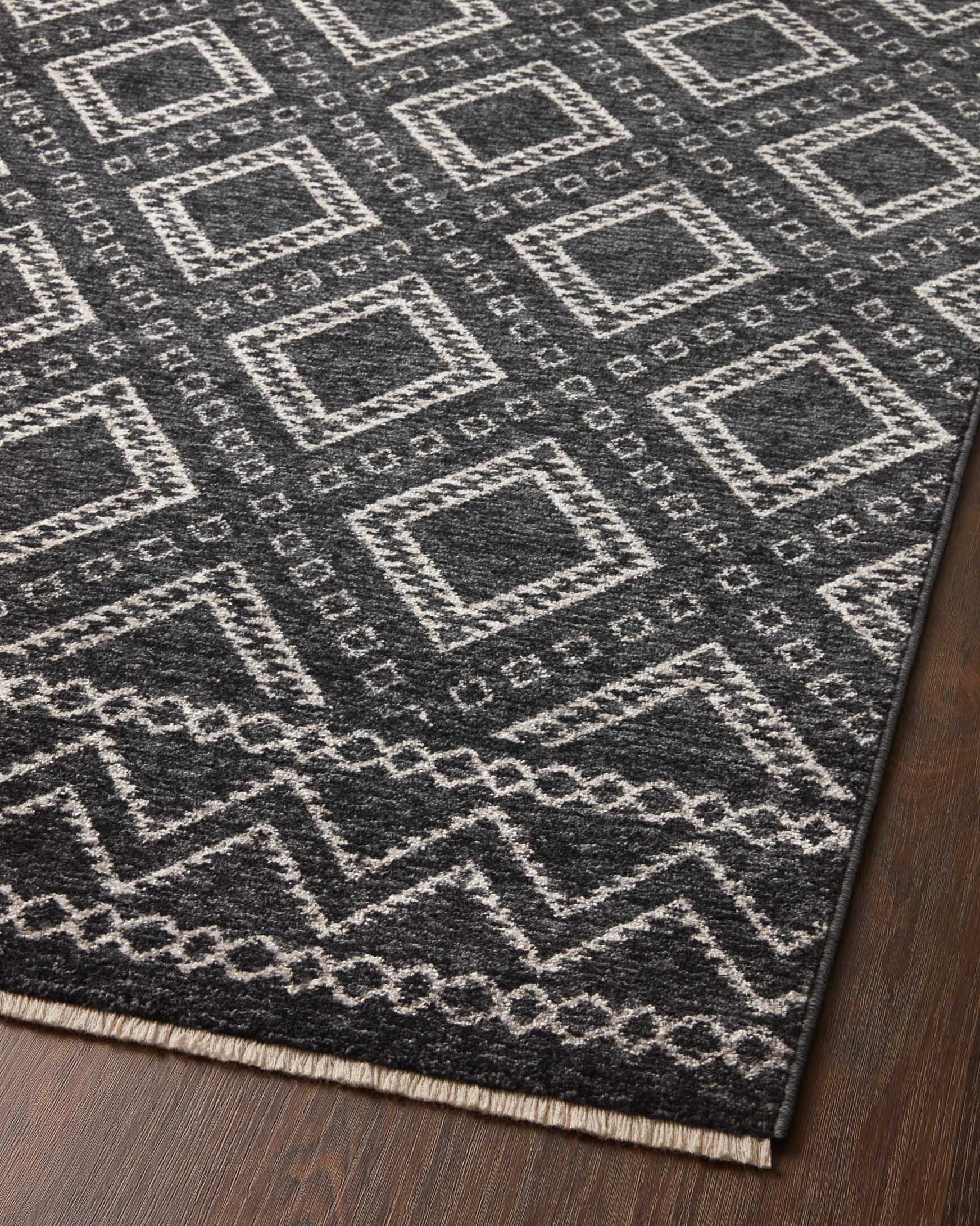 Charcoal rug with dove diamond lattice and zigzag pattern, angled corner