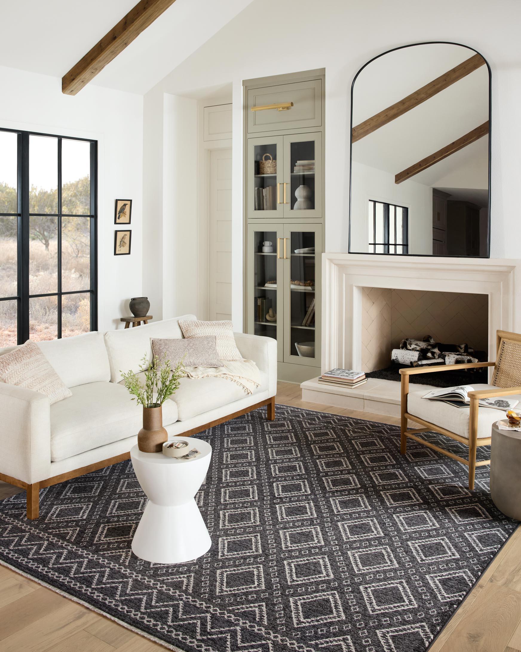 Charcoal rug with dove geometric diamond pattern on hardwood flooring