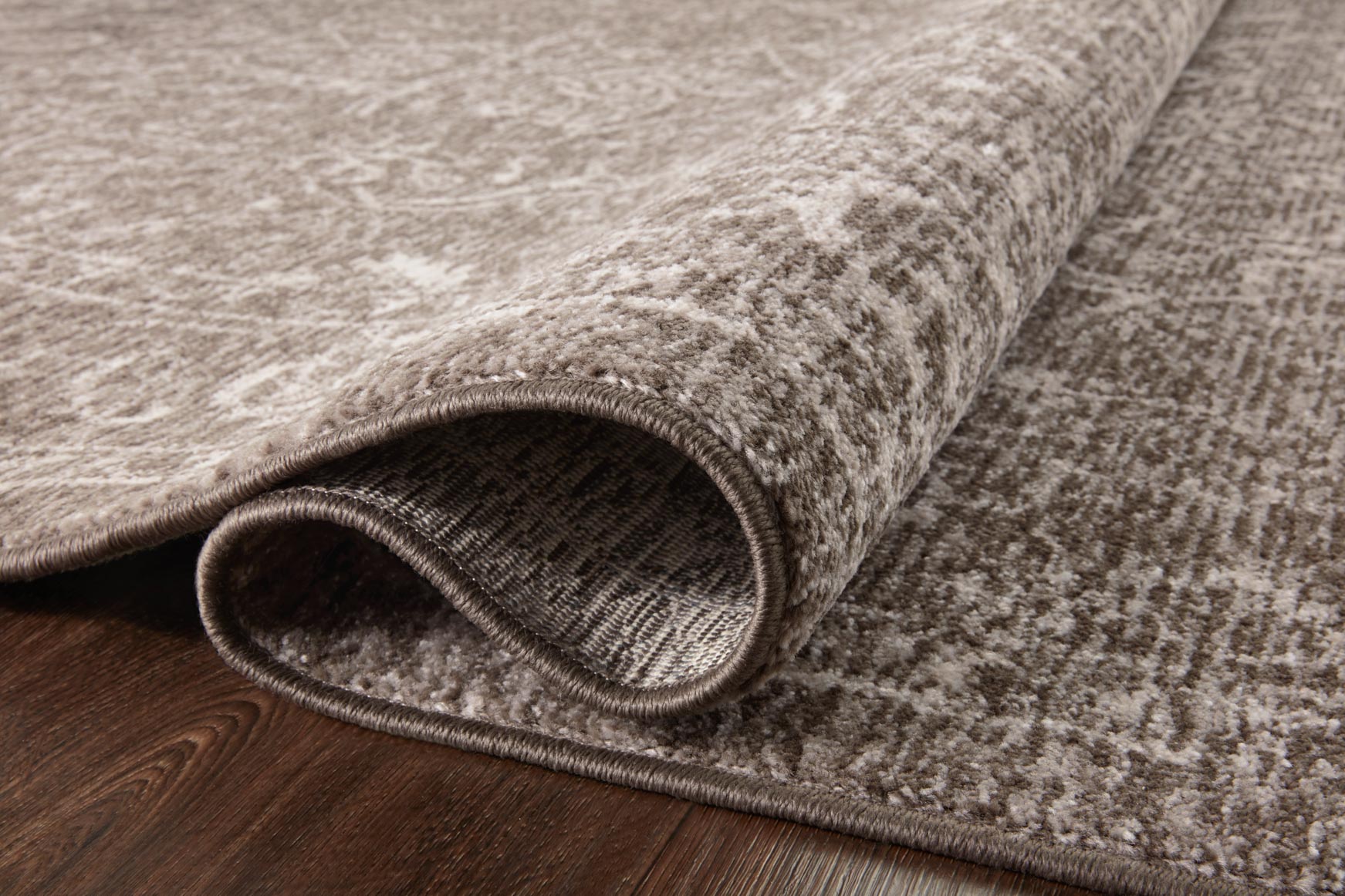 Taupe and dove rug with textured low pile and bound edge