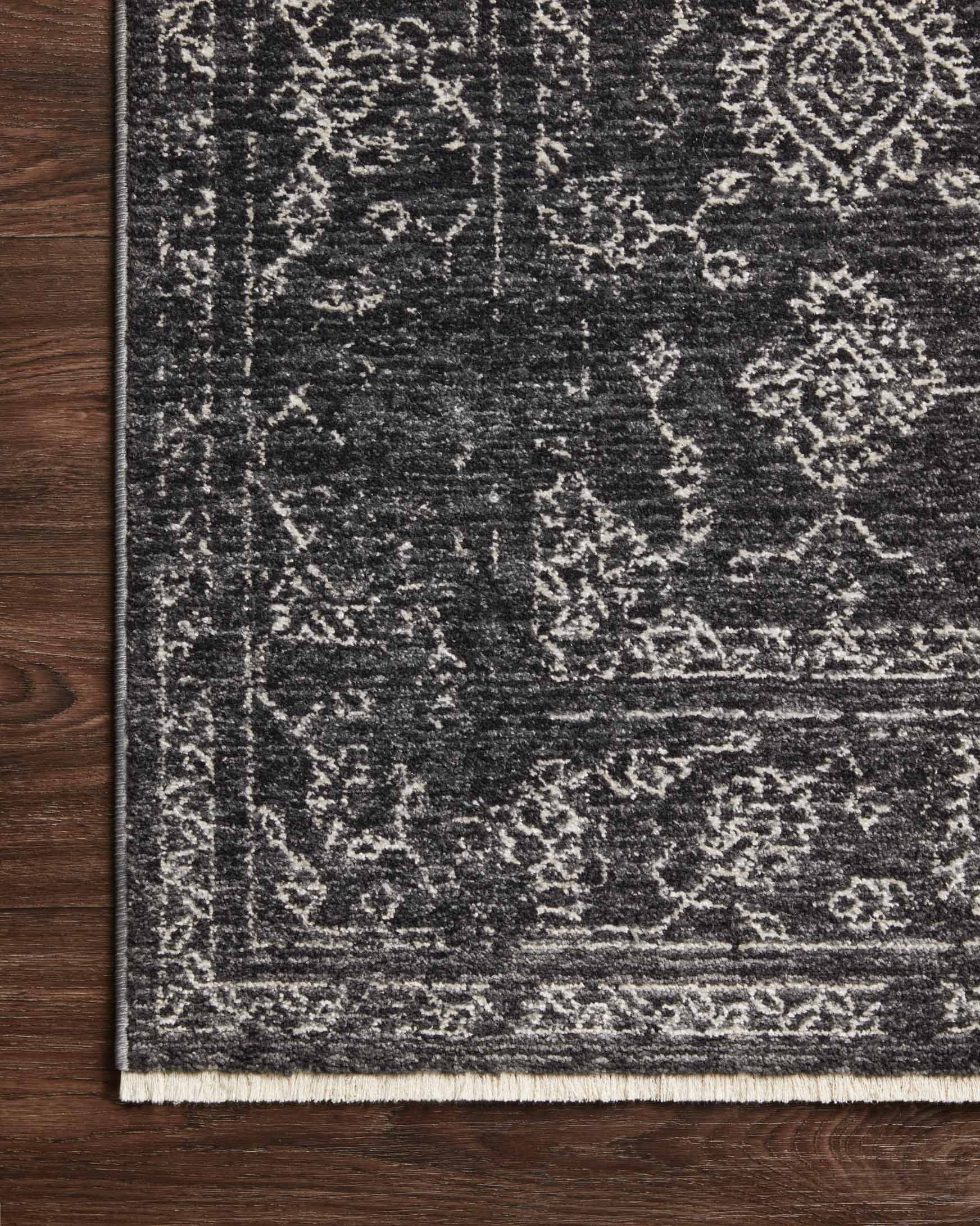 Charcoal and dove rug with detailed distressed pattern and light bound edge