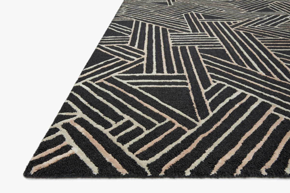 Charcoal hand-tufted rug corner view with bold geometric linework in beige