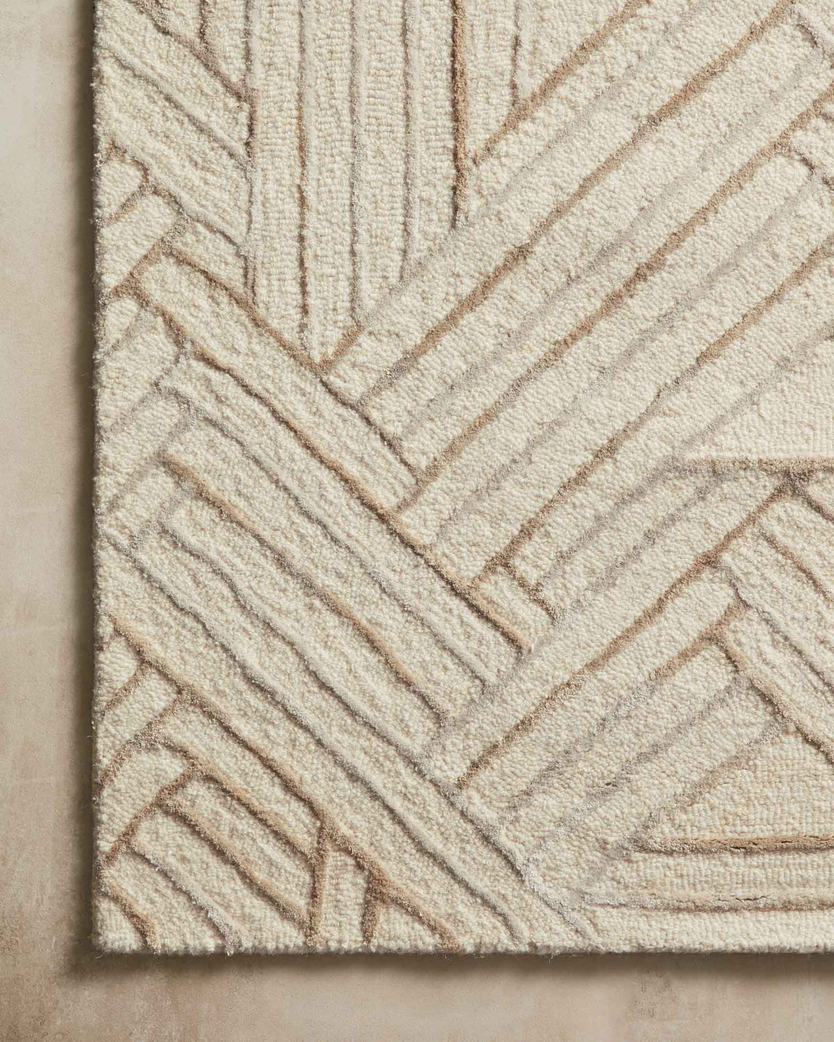 Ivory and oatmeal rug close-up showing hand-tufted texture and linear pattern