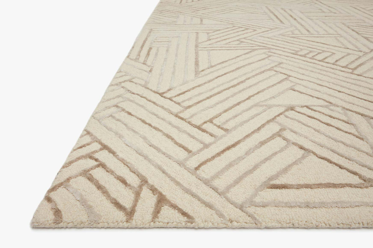 Ivory and oatmeal rug corner with textured hand-tufted geometric pattern