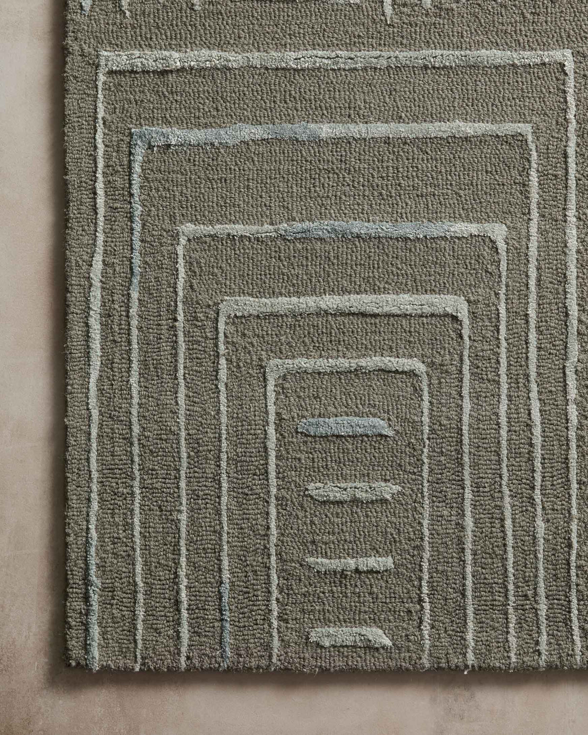 Grey and mist rug close-up showing layered concentric square line details