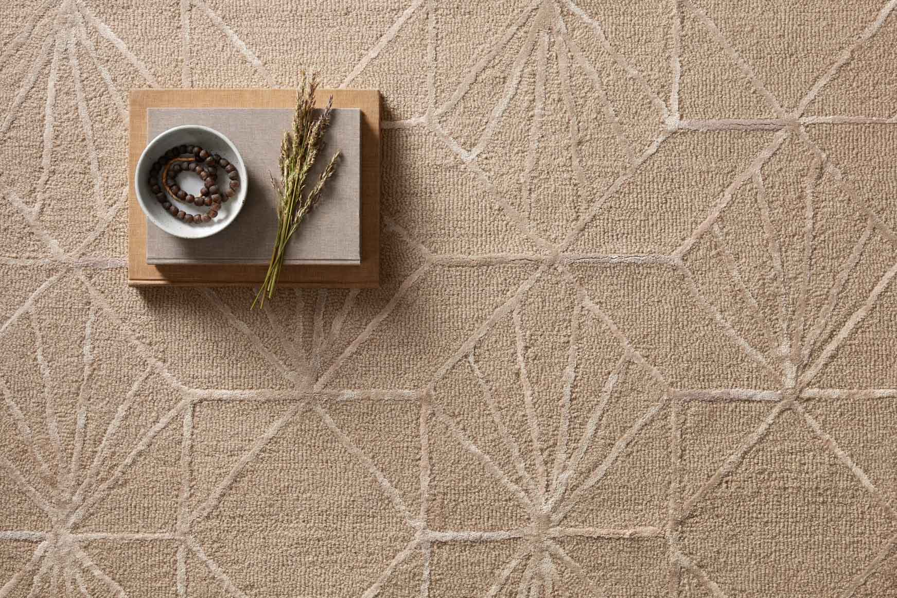 Sand and blush hand-tufted rug with fan-shaped geometric pattern and braided lines
