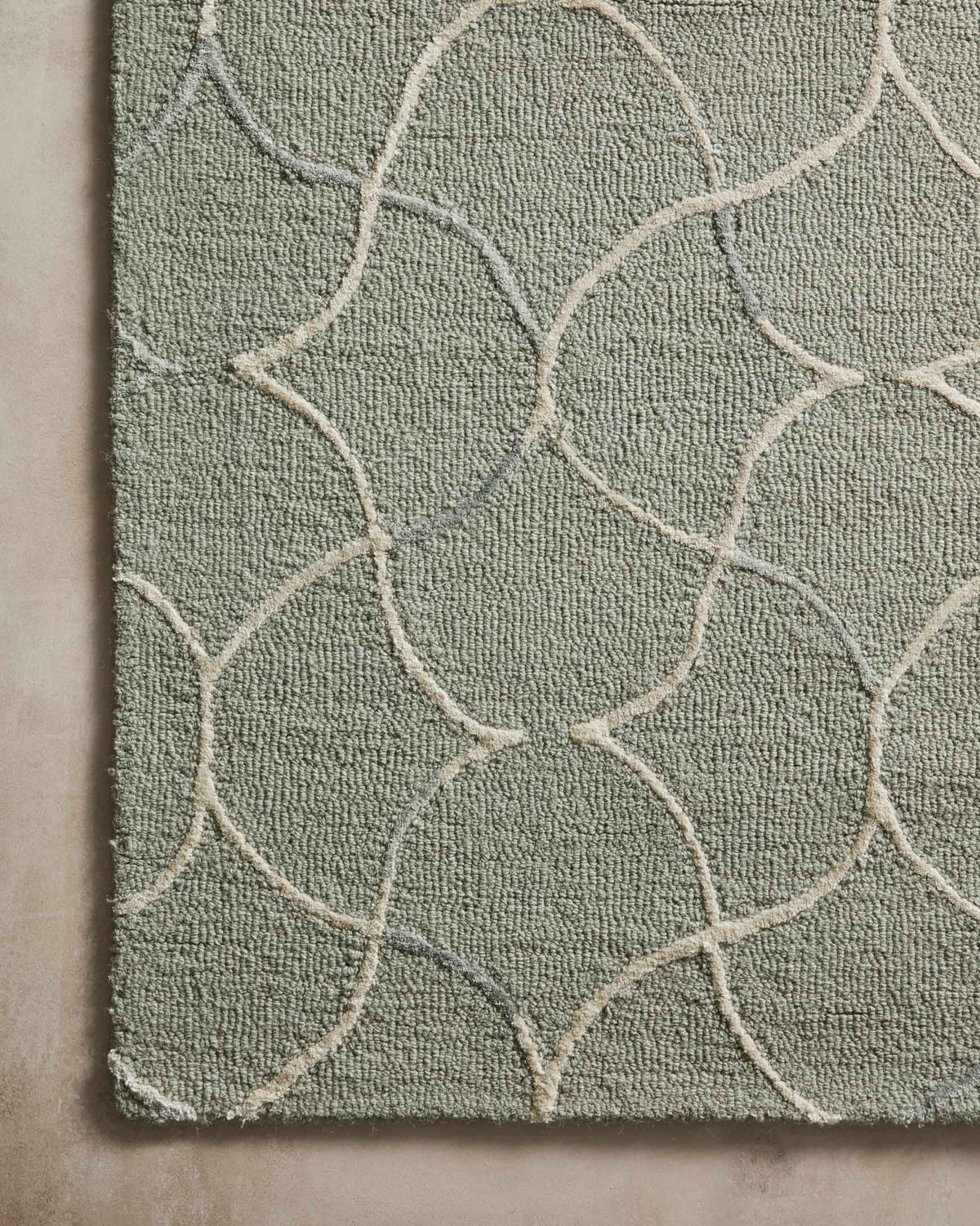 Sage and silver hand-tufted rug with raised loops and curved white trellis lines