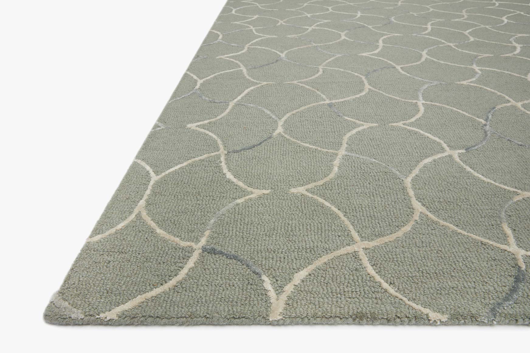 Sage rug corner with white trellis lattice pattern, hand-tufted loop texture