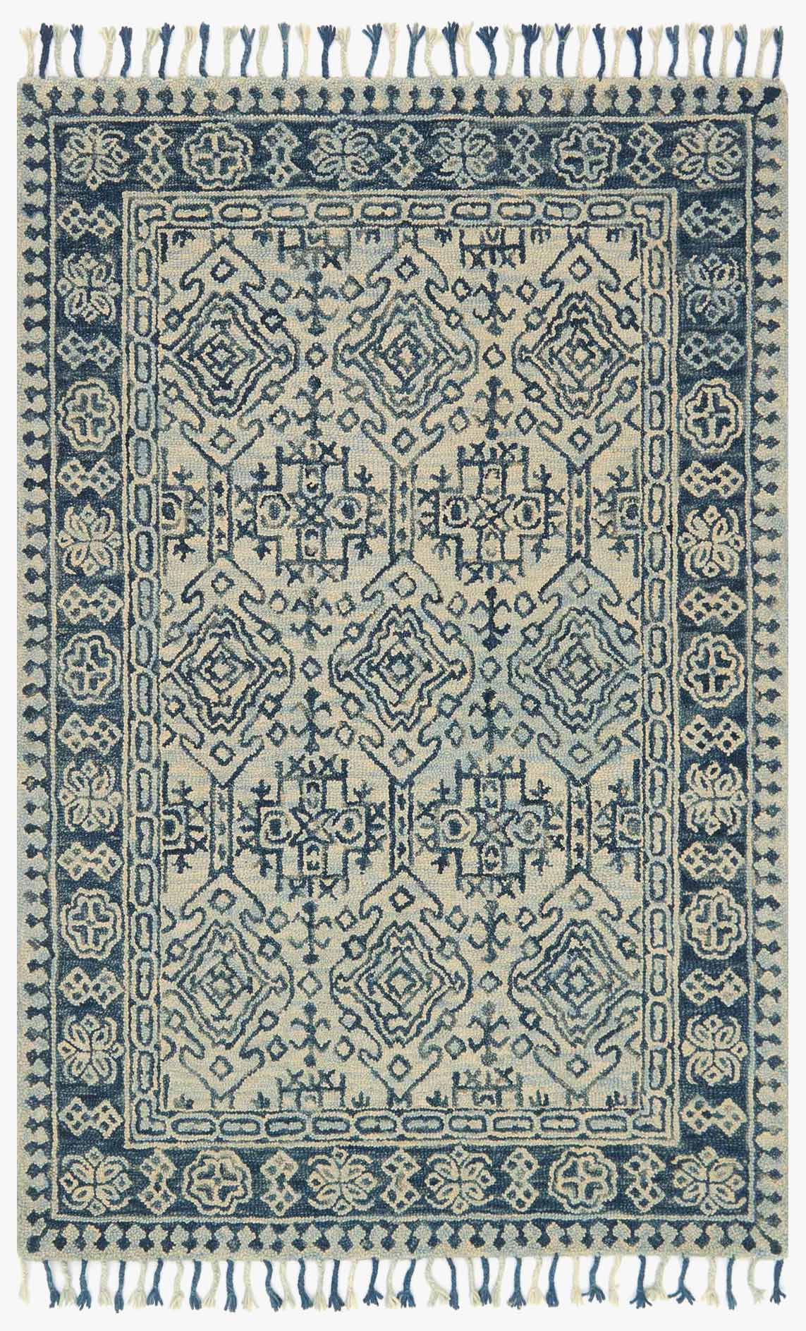 Transitional hooked rug in mist and blue with geometric border and short fringed edges