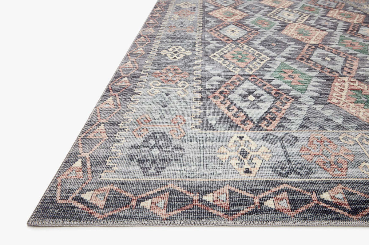 Corner view of grey geometric rug with diamond motifs and multicolor accents