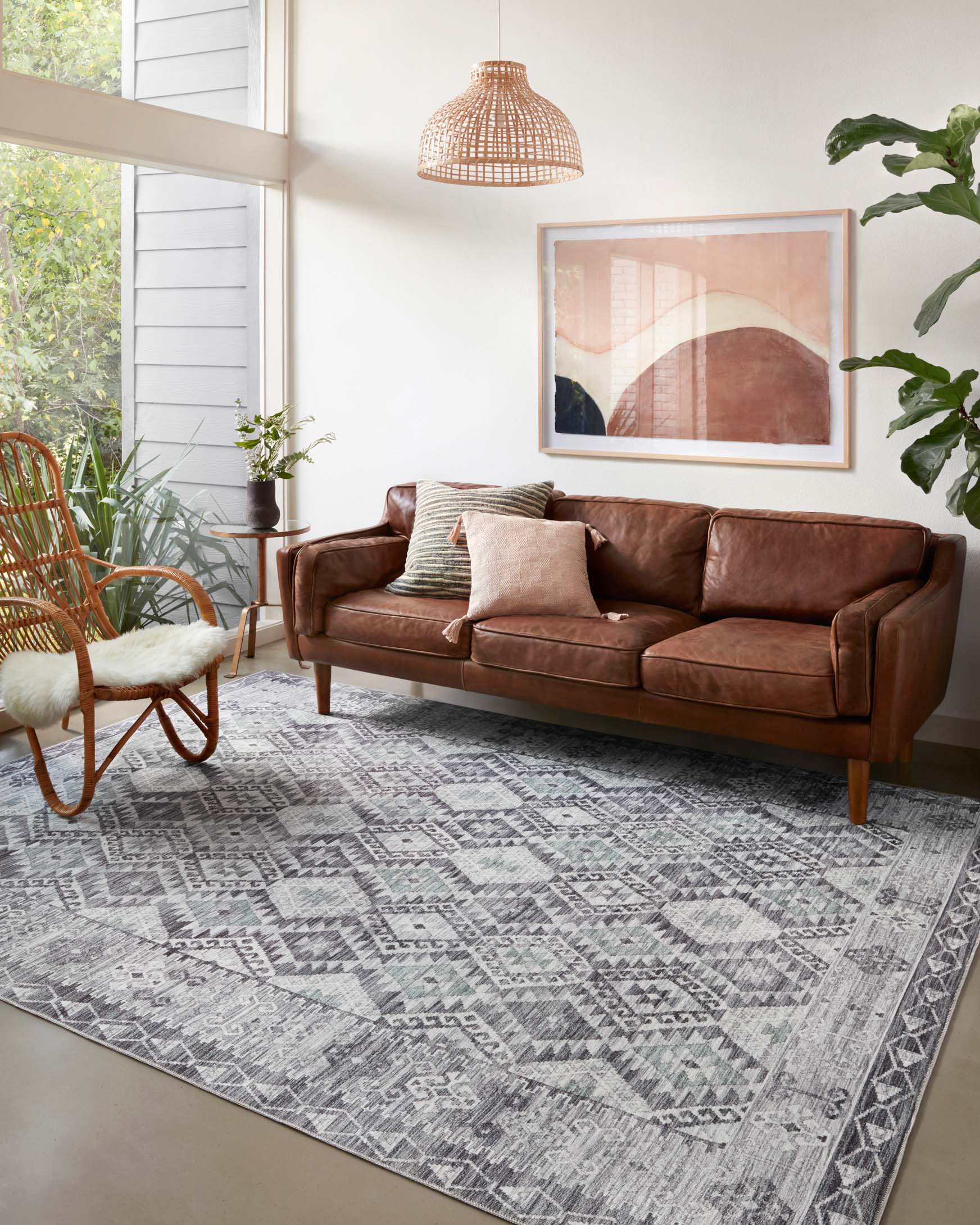 Charcoal and slate geometric traditional area rug on floor in living room setting
