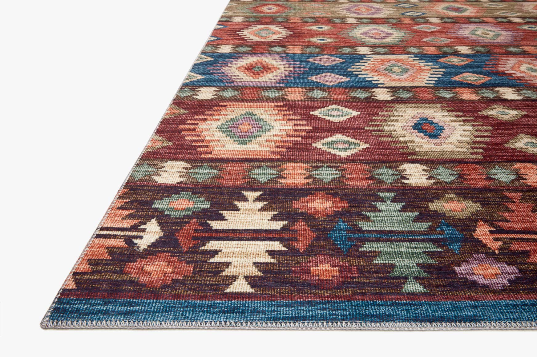 Corner view of multicolor geometric rug with diamond patterns and zigzag border