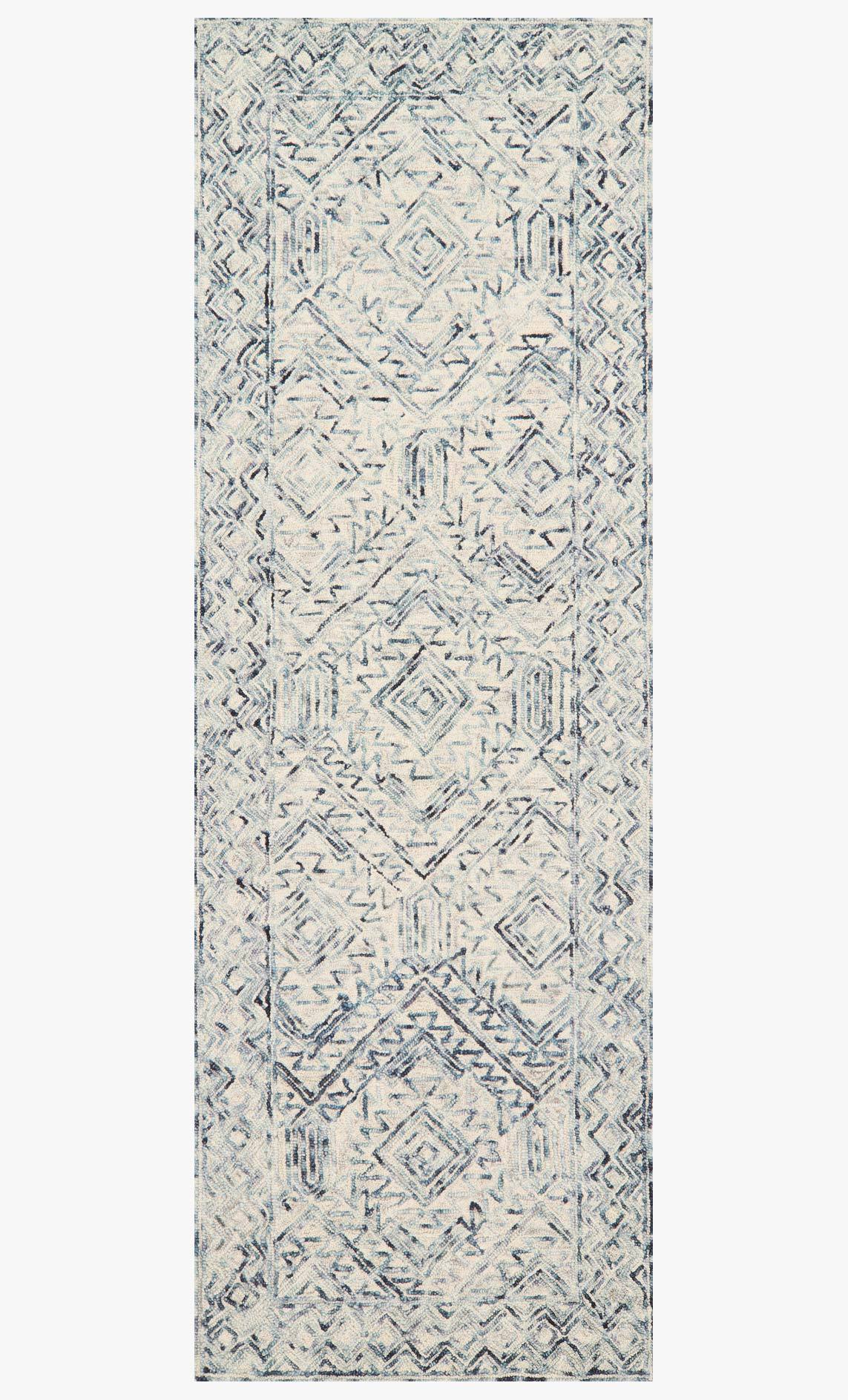 Contemporary hand-tufted rug with repeating geometric pattern in bluestone and ivory