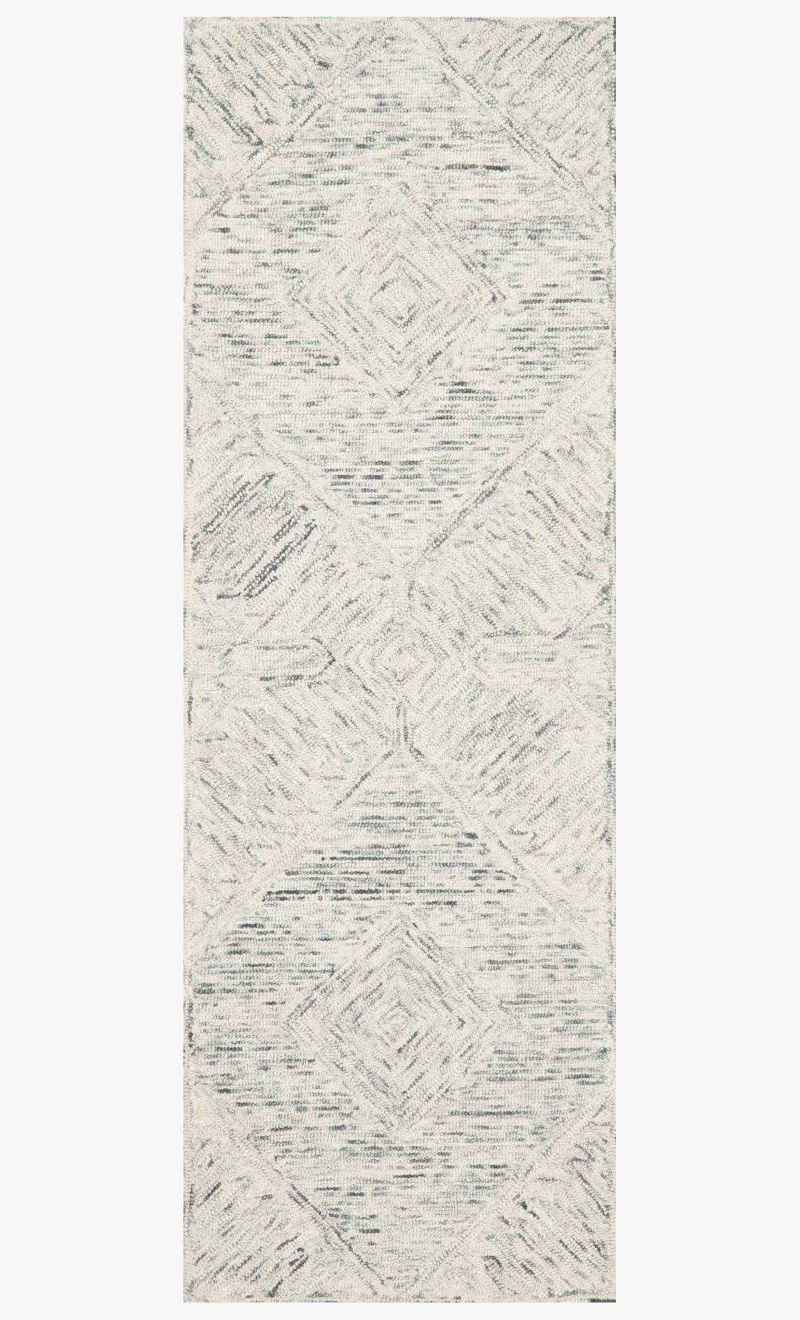 Sky-blue hand-tufted rectangular rug with distressed geometric pattern and textured finish